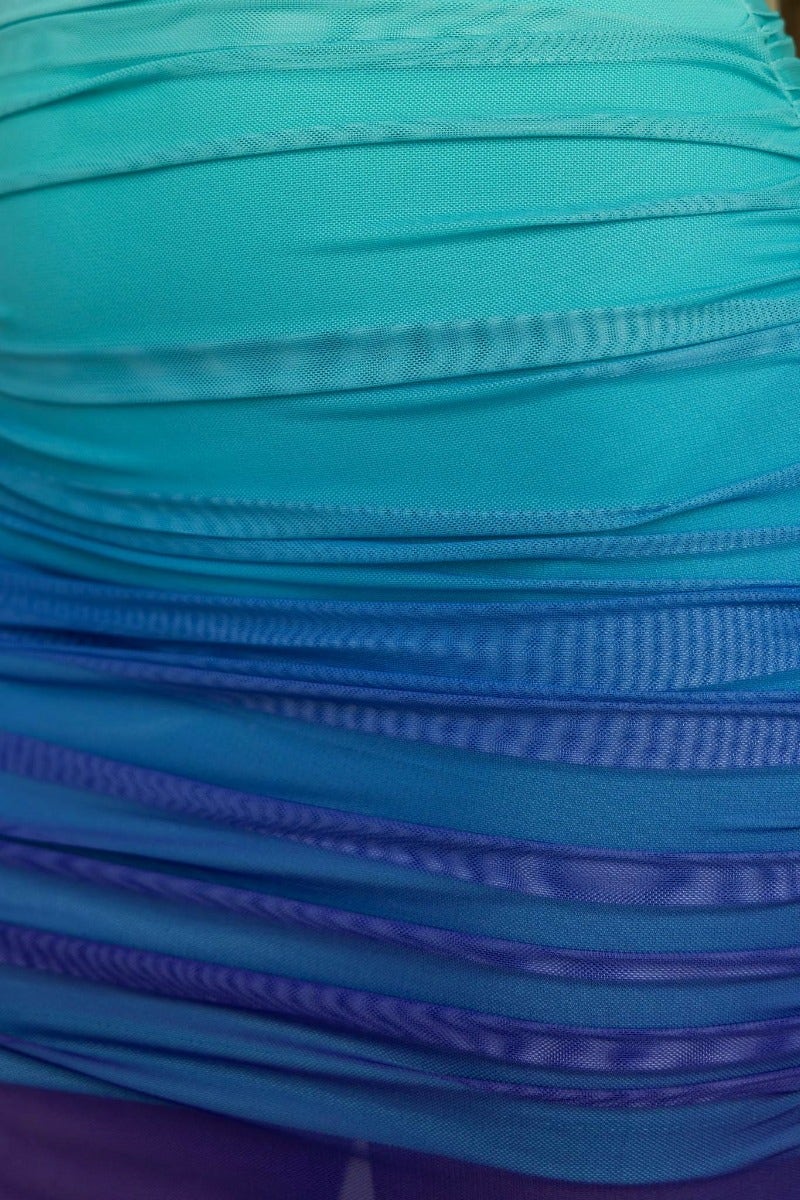 Close-up of ruched mesh overlay fabric in gradient aqua to blue, featured on the Velocity Maxi Dress.