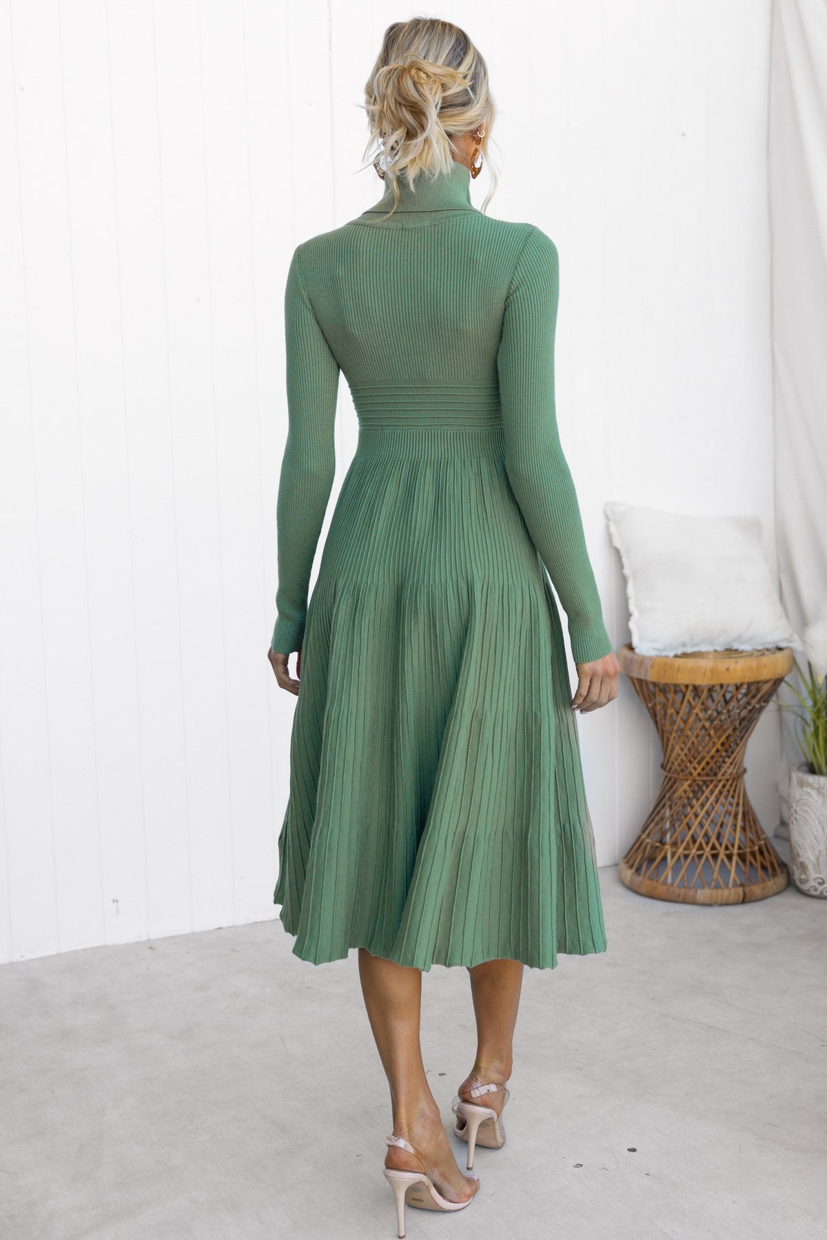Back view of a green Parkley Midi Dress with turtle neckline and pleated skirt, showcasing its sleek design and fit.