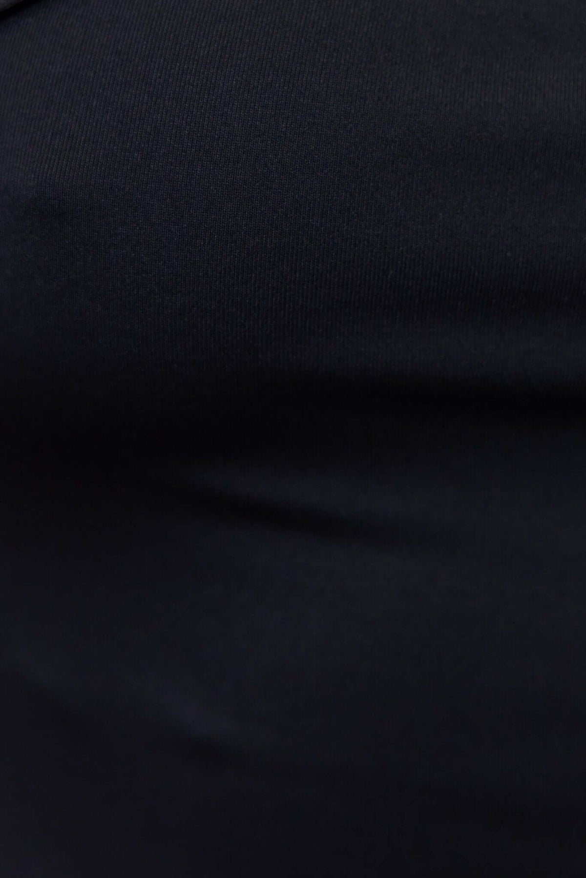 Close-up of the black Adrano bodysuit fabric, showcasing its stretch and smooth texture.