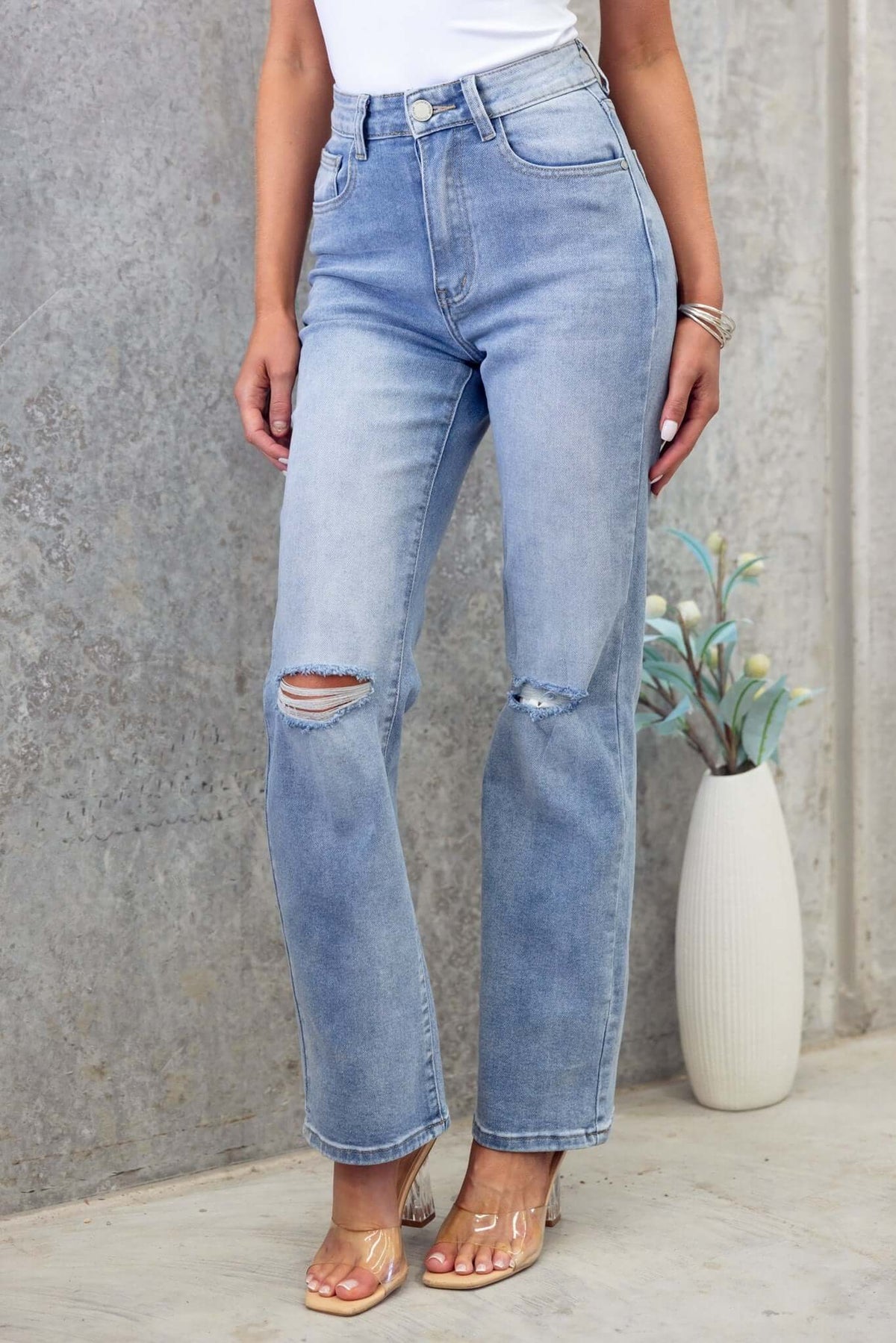 Distressed Tekin jeans with rip details, featuring pockets and a classic light blue wash.