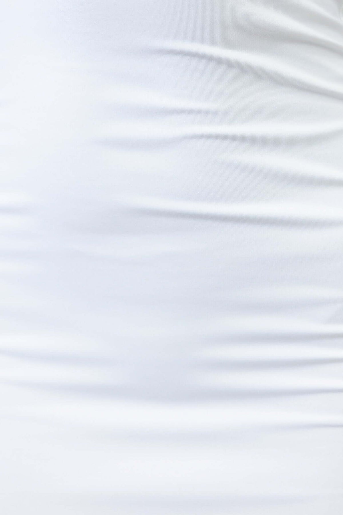 Close-up of the texture of a white stretchy fabric, showcasing its softness and smooth finish for clothing designs.