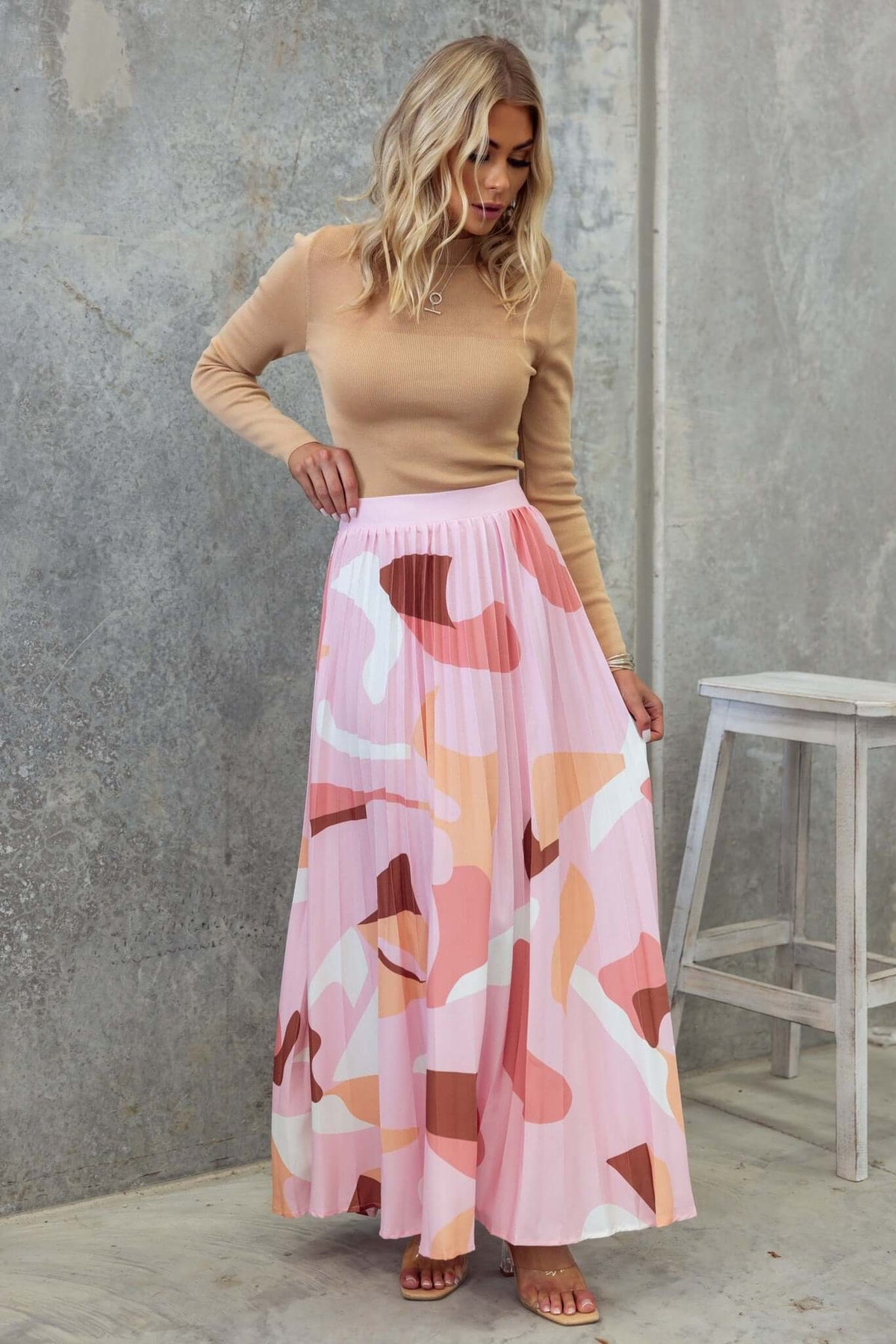 Model wearing Bankston Maxi Skirt with colorful pleats, styled with a beige top on a neutral background.