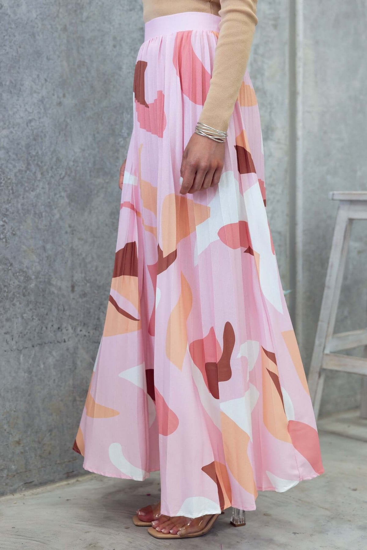 Elegant pink patterned Bankston Maxi Skirt with a mid-high waist and pleats, showcasing a stylish, flowing design.