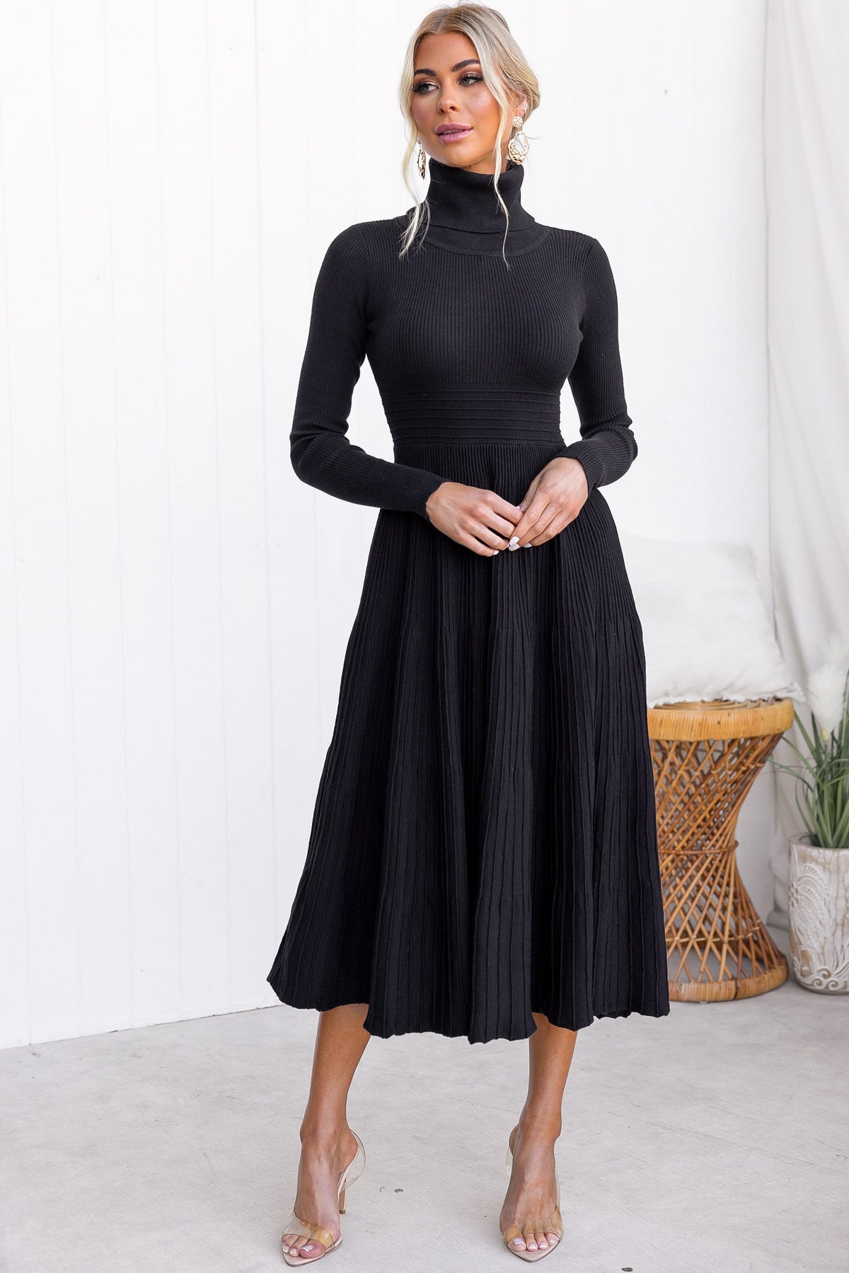 Elegant black Parkley midi dress with turtle neckline and ribbed knit material, showcasing a standard fit and flowy skirt.