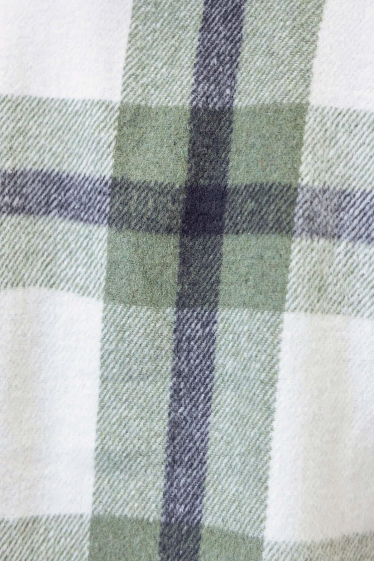 Close-up of Phillips Coat fabric featuring a green and white plaid pattern, showcasing the soft wool blend texture.