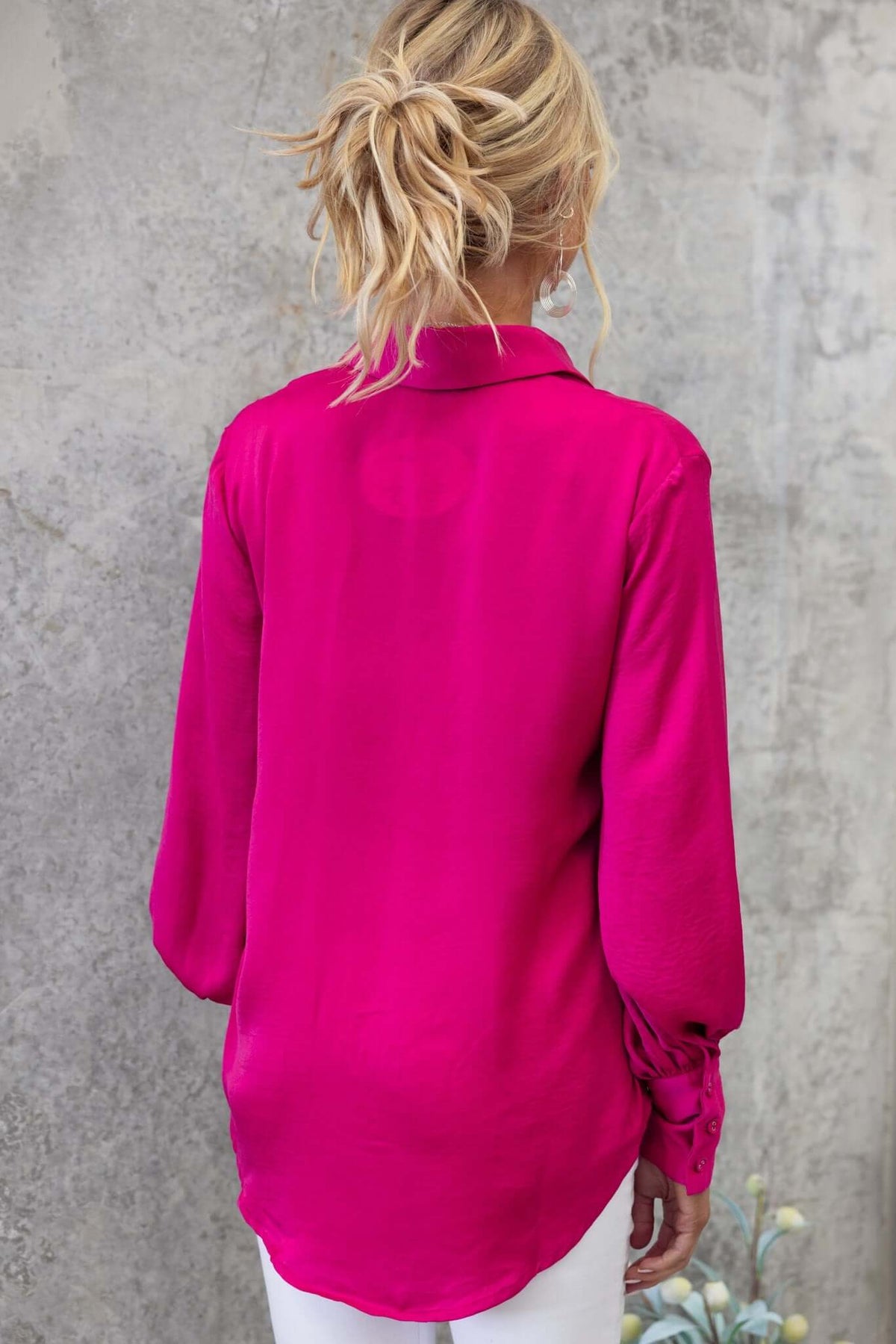 Back view of Ravia Shirt in vibrant fuchsia, featuring a collar and relaxed fit. Perfect for casual wear.
