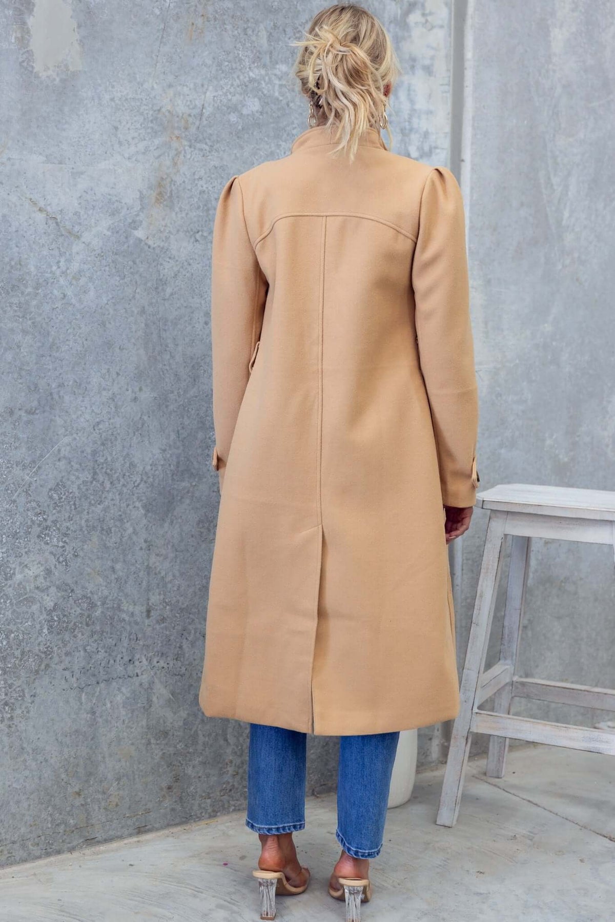 Back view of the Ortona coat in beige, featuring a longline fit, button-up design, and elegant collar.