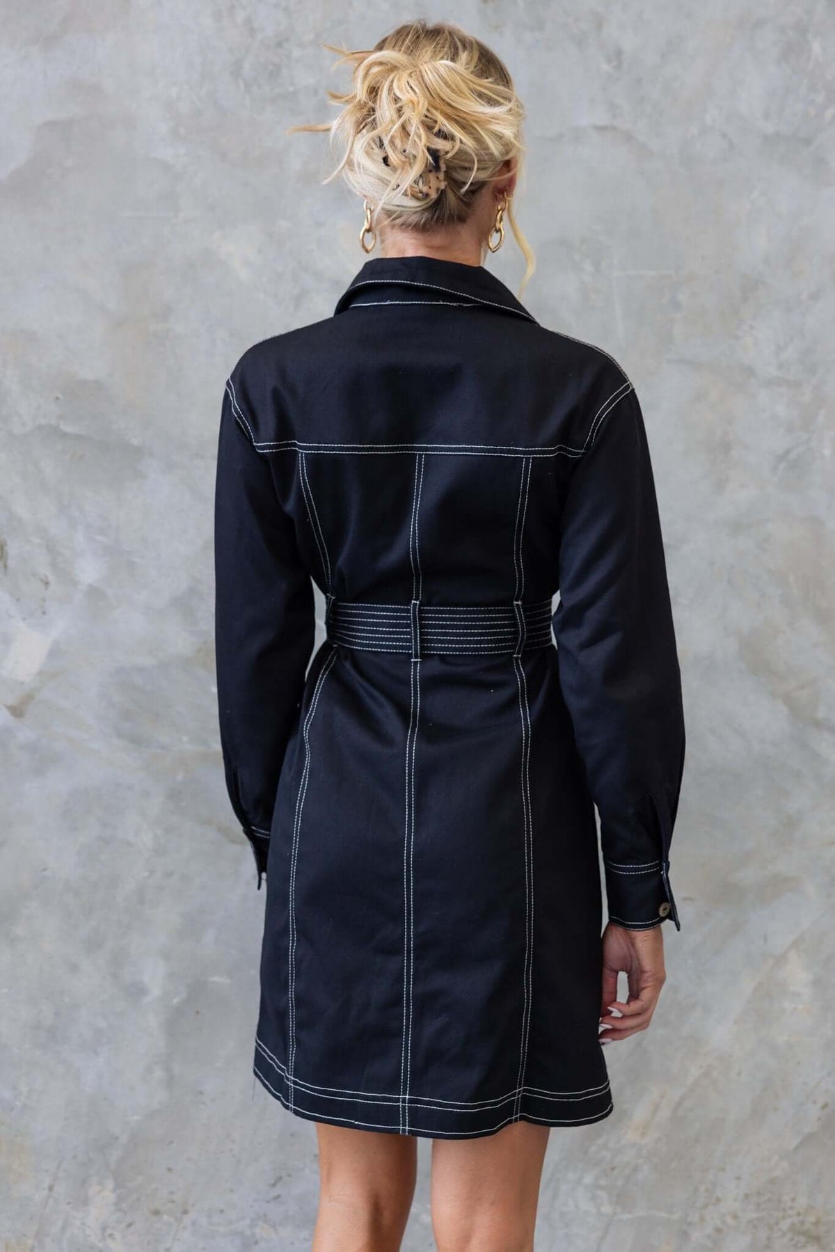 Back view of the Lisa Denim Dress in black, featuring a collar, button-up front, and a removable belt.
