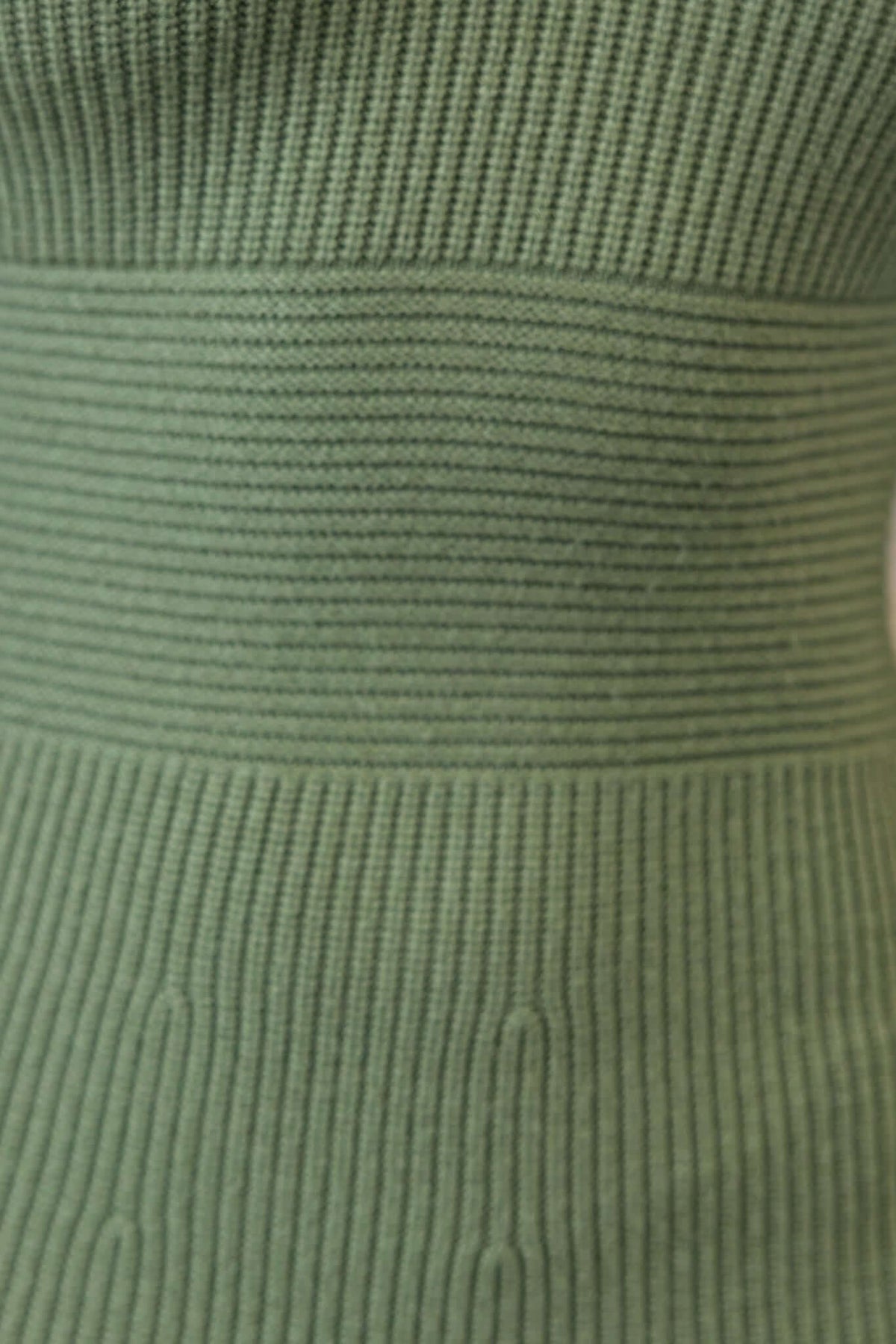 Close-up of ribbed knit material in soft green, showcasing texture and stretch of the Farina Maxi Dress.