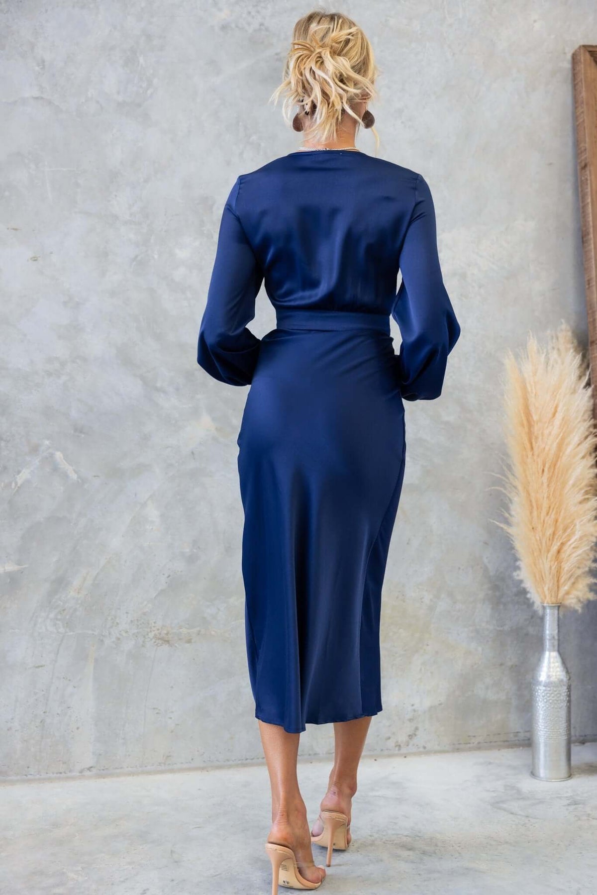 Back view of the elegant navy Cremona Midi Dress with satin finish and balloon sleeves.