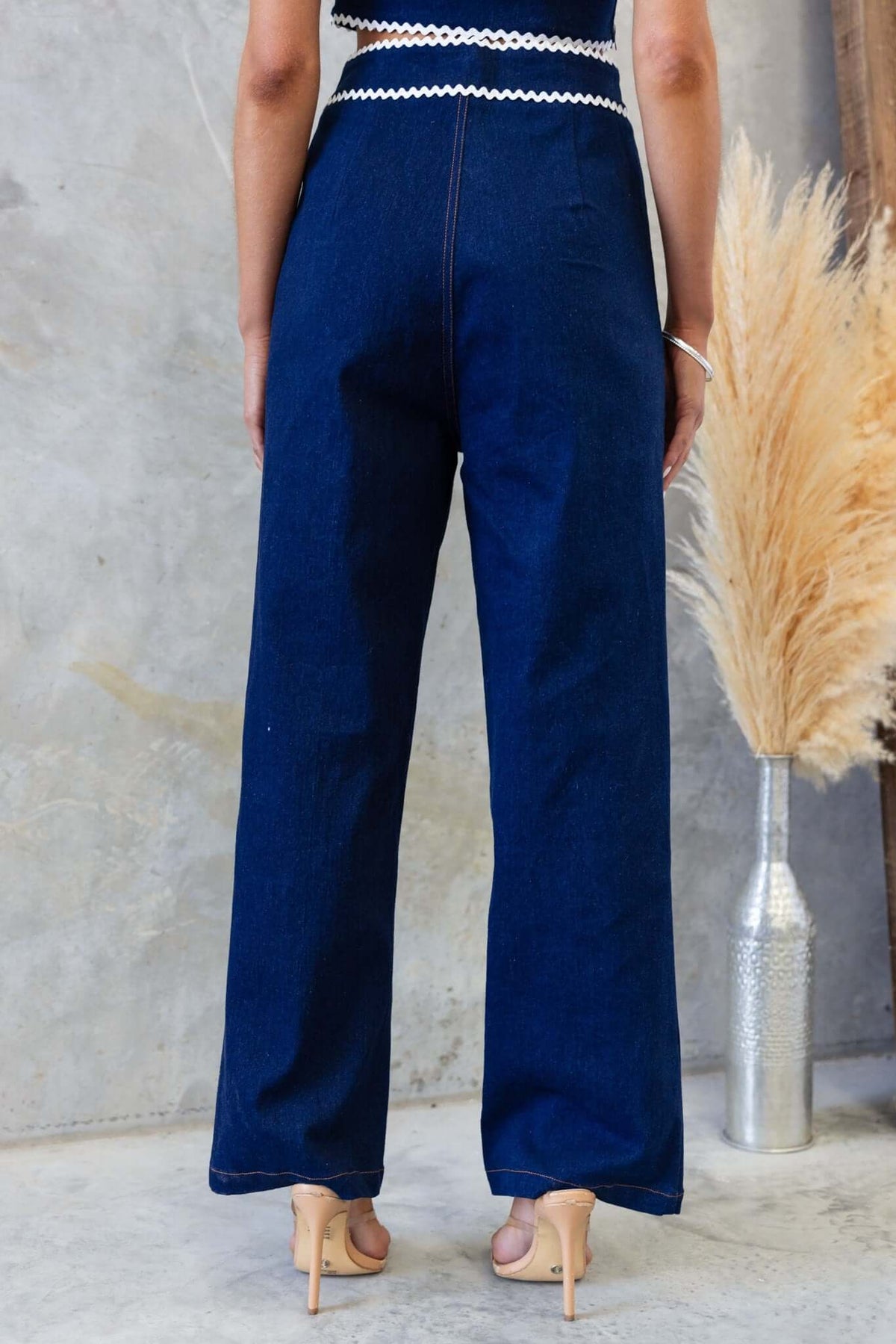 Back view of Favara Jeans showcasing mid-high waist fit and stylish dark denim material, perfect for casual outfits.