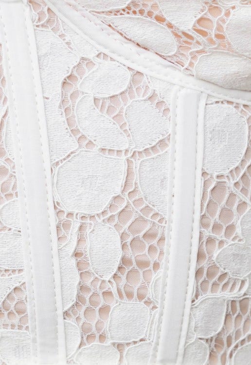 Close-up of lace bodice detail on Sweet Talker Dress, featuring floral patterns and elegant texture.