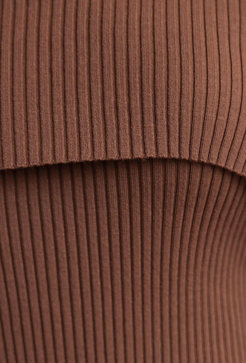 Close-up of ribbed fabric texture in brown, showcasing the stylish design of the Devoted Midi Dress.