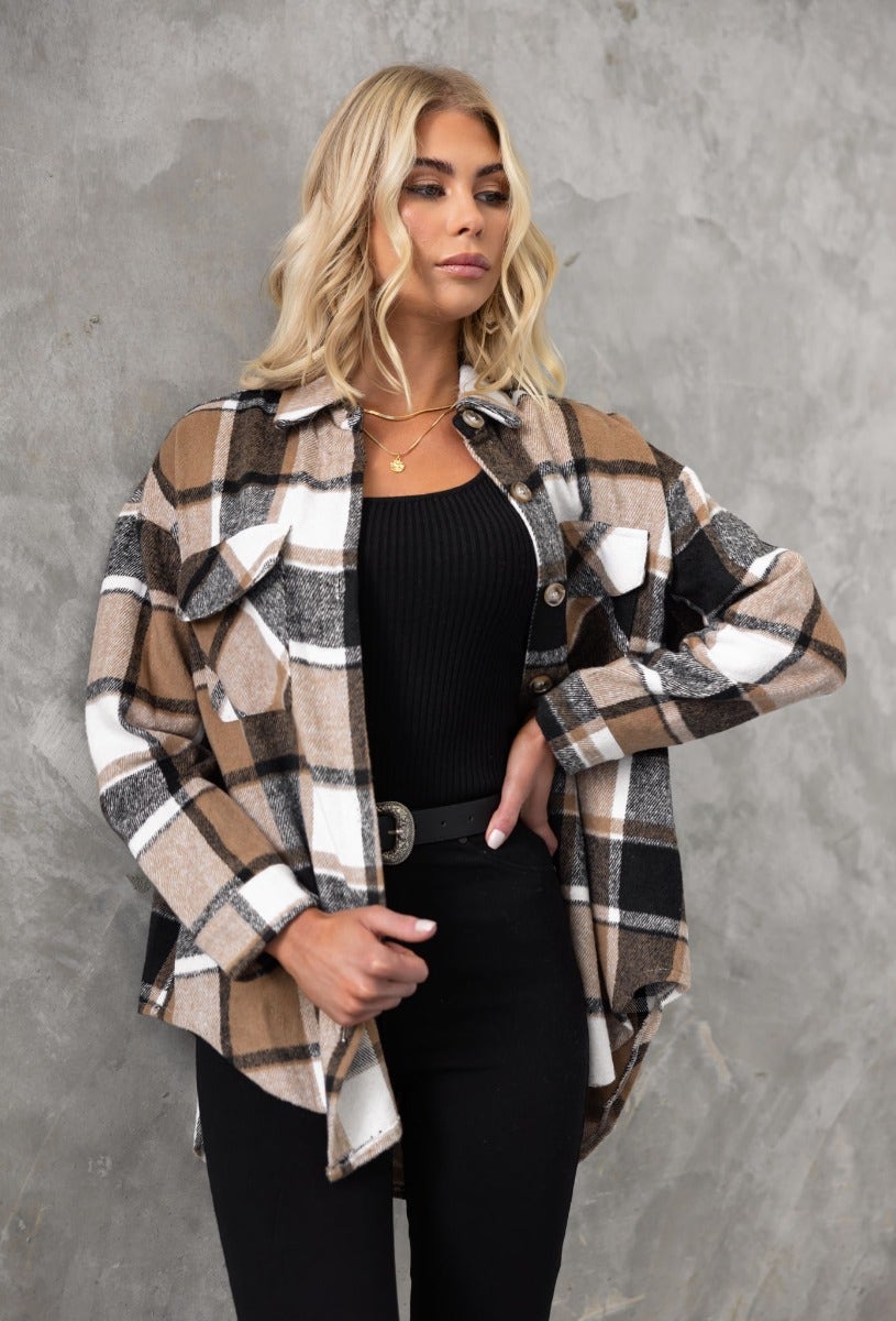 Stylish Gable shacket in plaid print, featuring button-up front and pockets, paired with a black top and jeans.