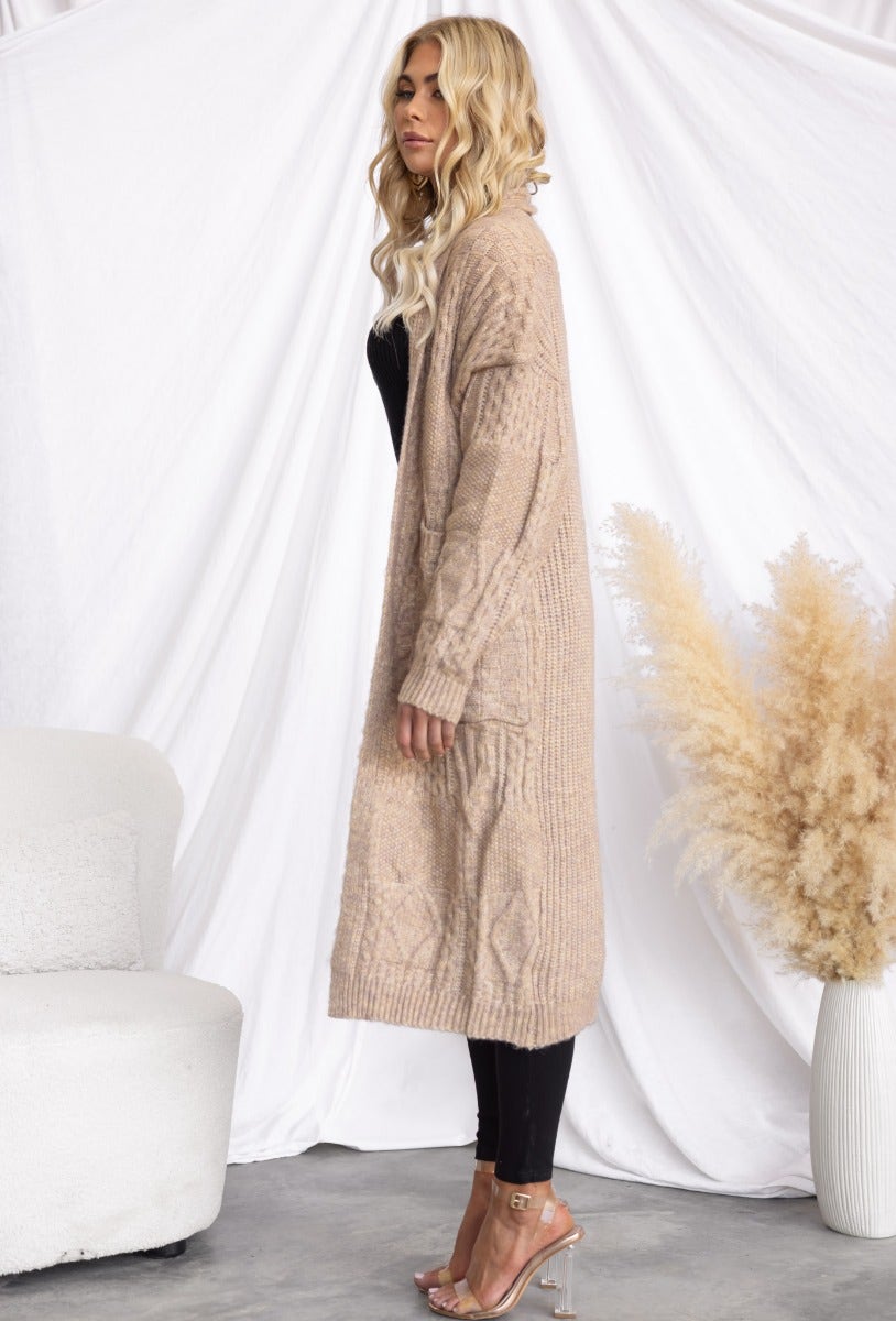 Emerson Cardigan in cable knit style, longline fit with pockets, on model against a neutral background.