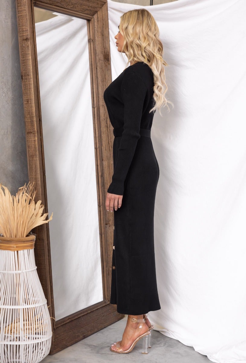 Black ribbed Nicola maxi dress with round neckline and faux button-up front, styled with a removable fabric belt.