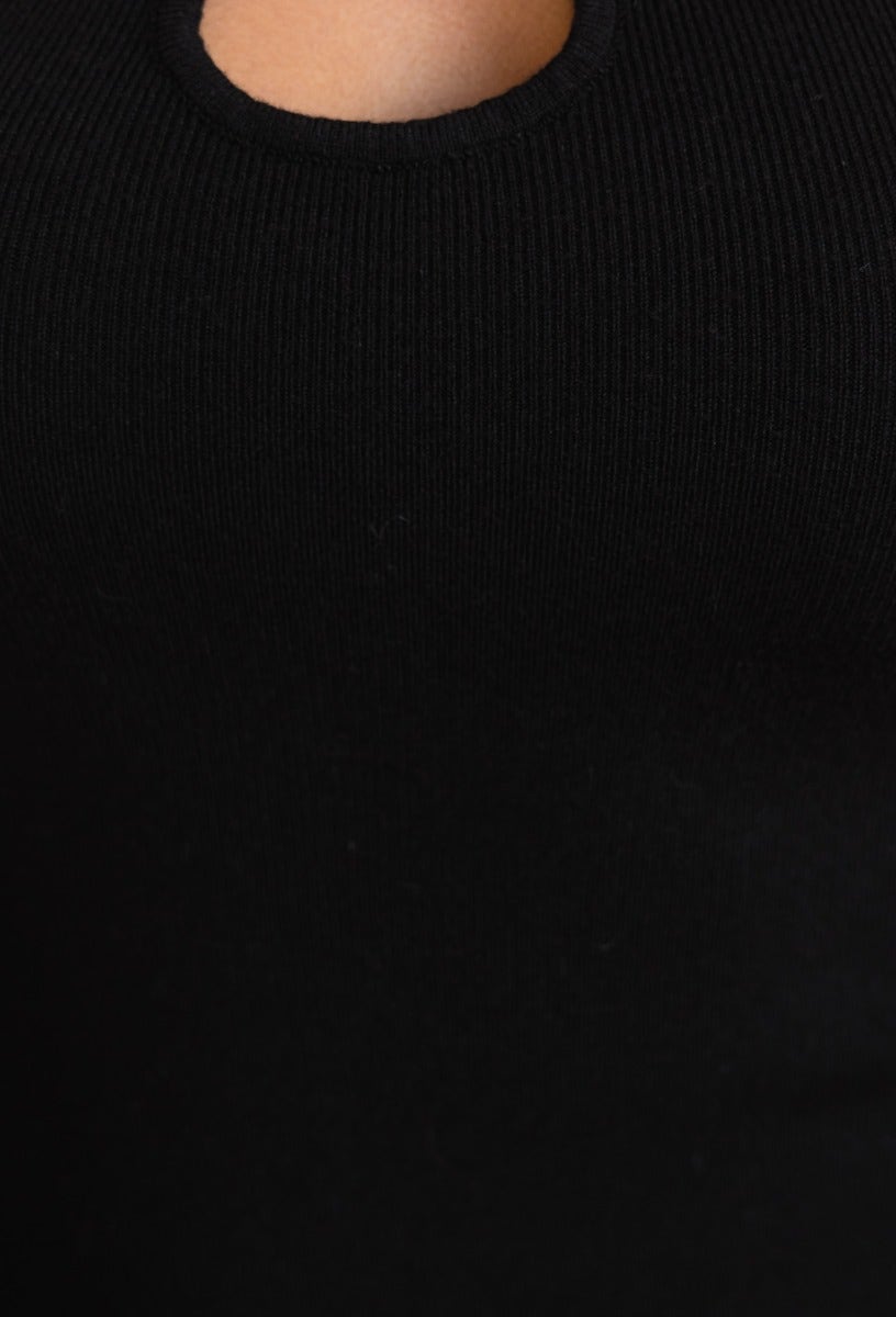 Close-up of black ribbed knit dress showcasing cut-out neckline and stretchy fabric detail.