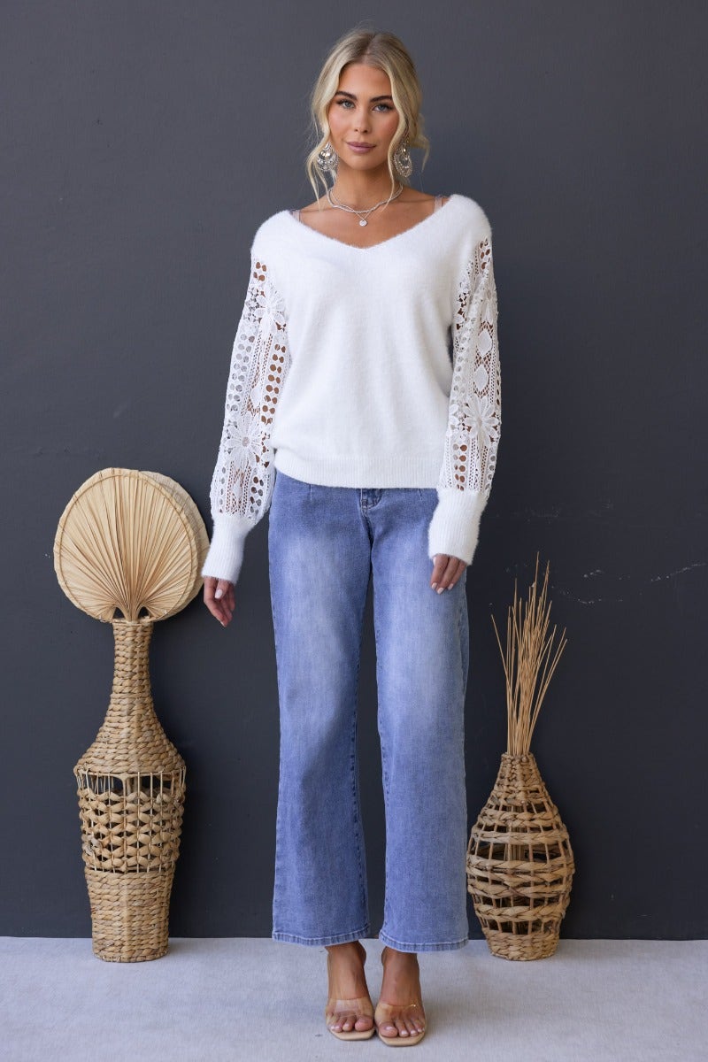 Indya Jumper featuring a fluffy knit design, V-neckline, and lace sleeves worn with stylish wide-leg jeans.