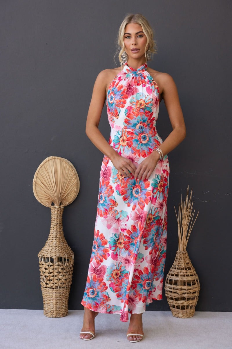 Floral print satin maxi dress with high tie neckline, featuring vibrant flowers and a flowing silhouette.