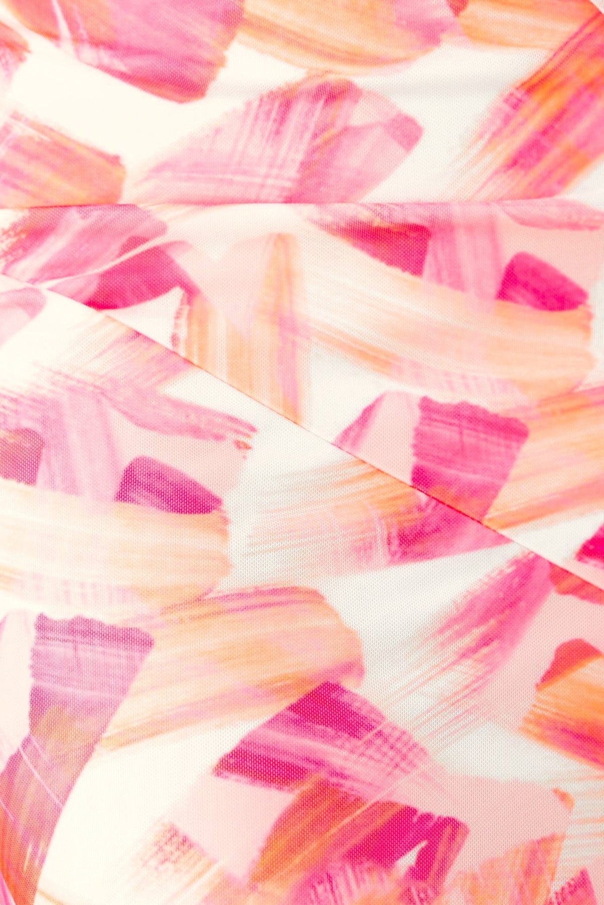 Close-up of floral print fabric with pink and orange brush strokes, perfect for a stylish maxi dress.