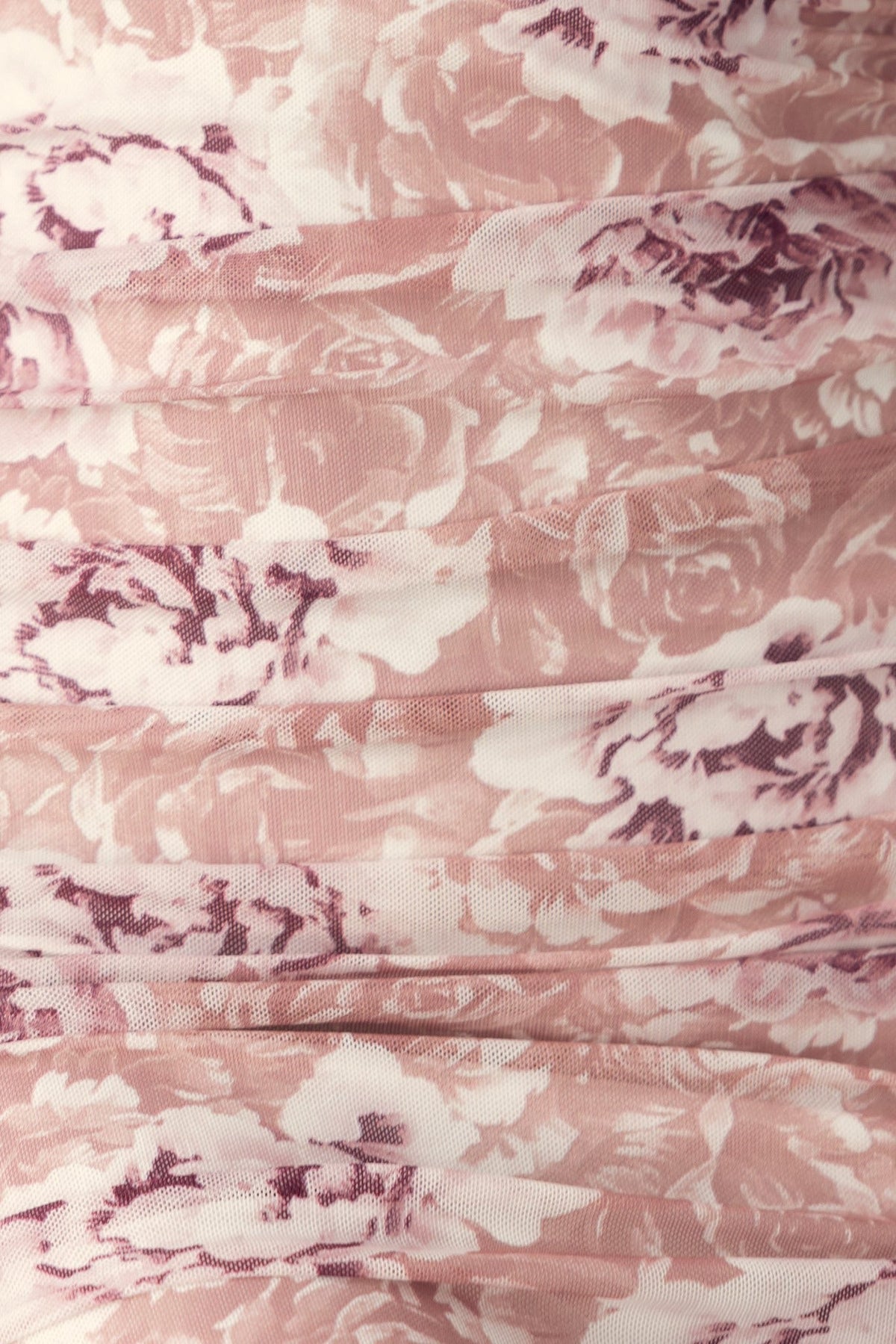 Floral print close-up of Overboard Midi Dress fabric in soft pink hues, showcasing intricate rose patterns and mesh overlay.
