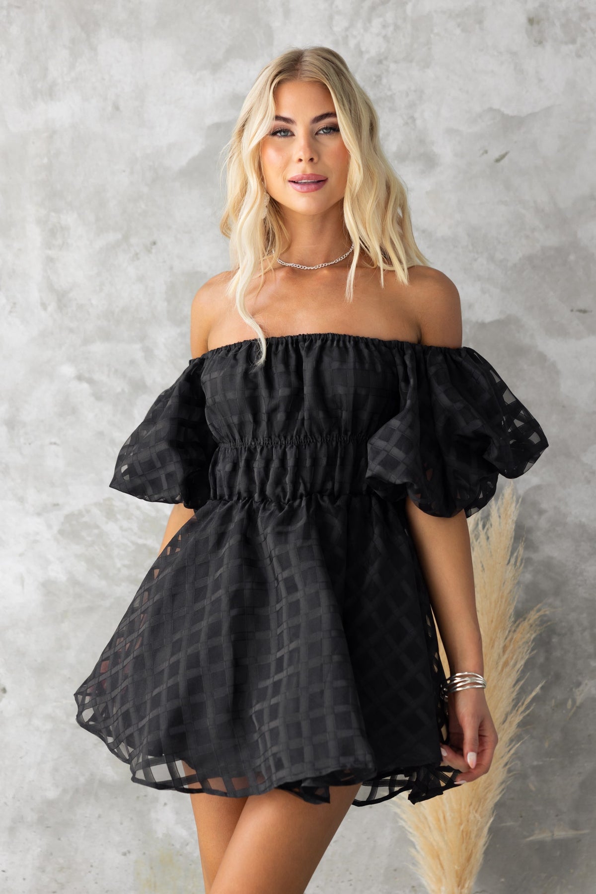 Zerali black off-shoulder dress with puff sleeves and elastic neckline, perfect for stylish summer occasions.
