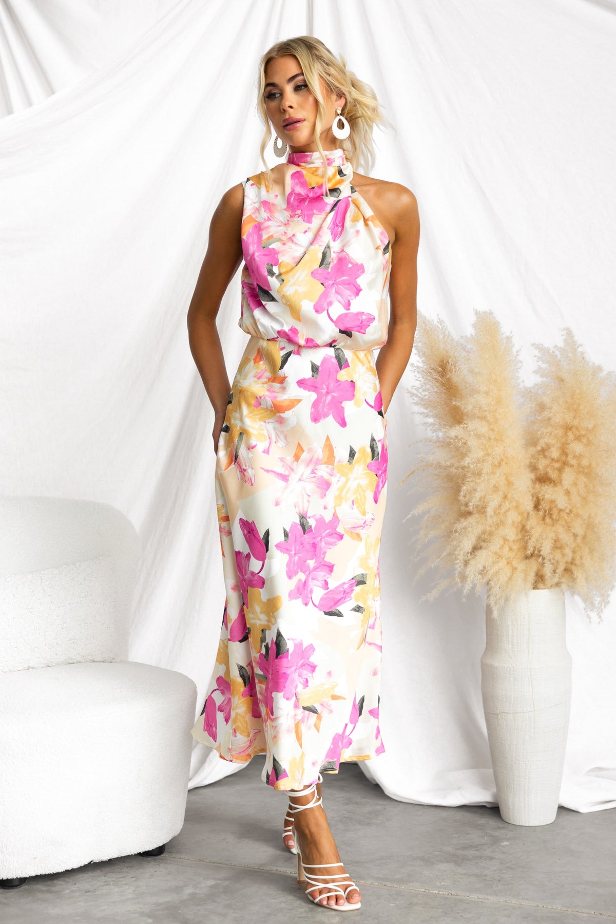 Irisse Midi Dress featuring a floral print, high neckline, and relaxed fit, stylishly modeled against a white backdrop.