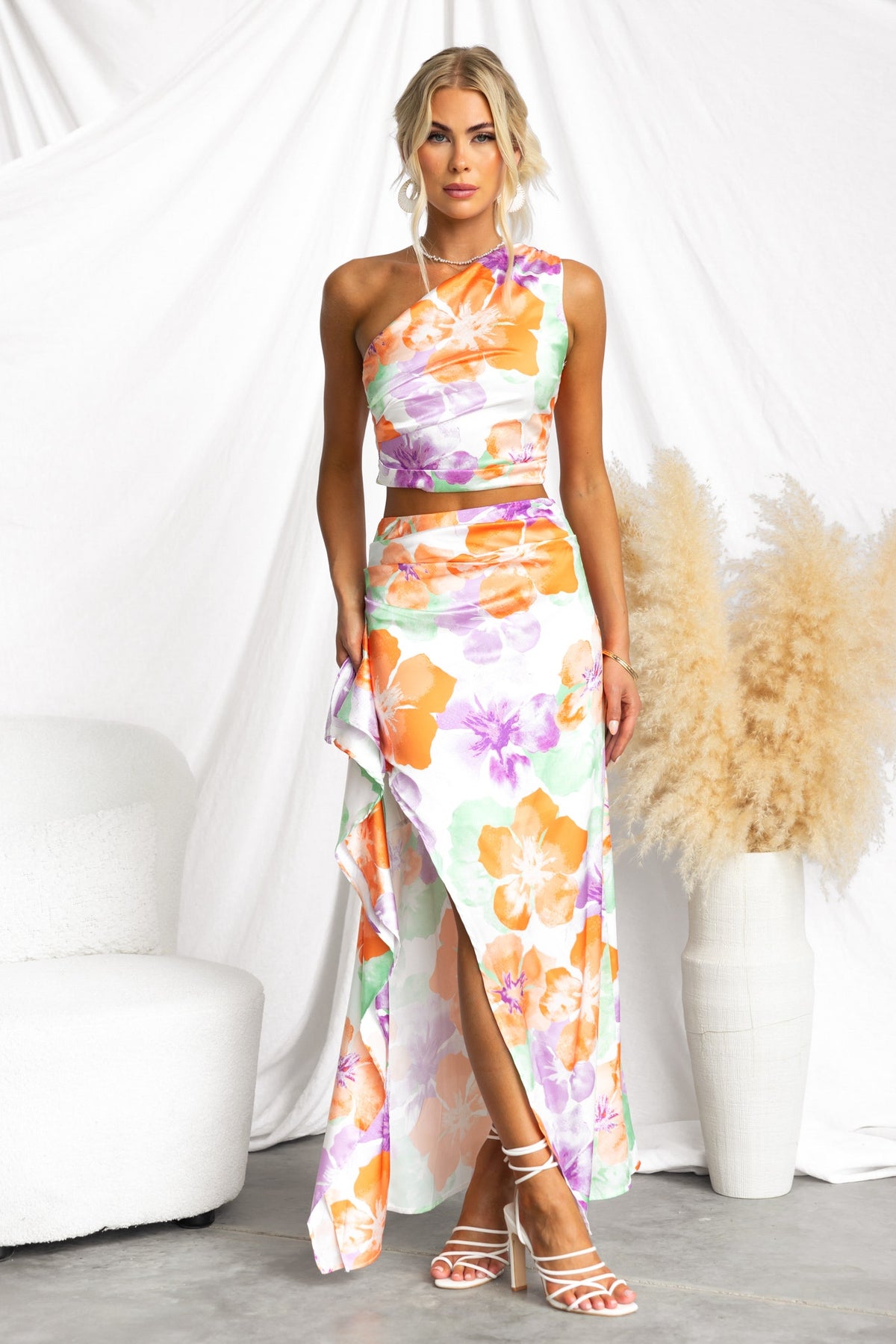 Vella Maxi Skirt featuring floral patterns, a side split, and a satin look, styled with matching top and strappy heels.