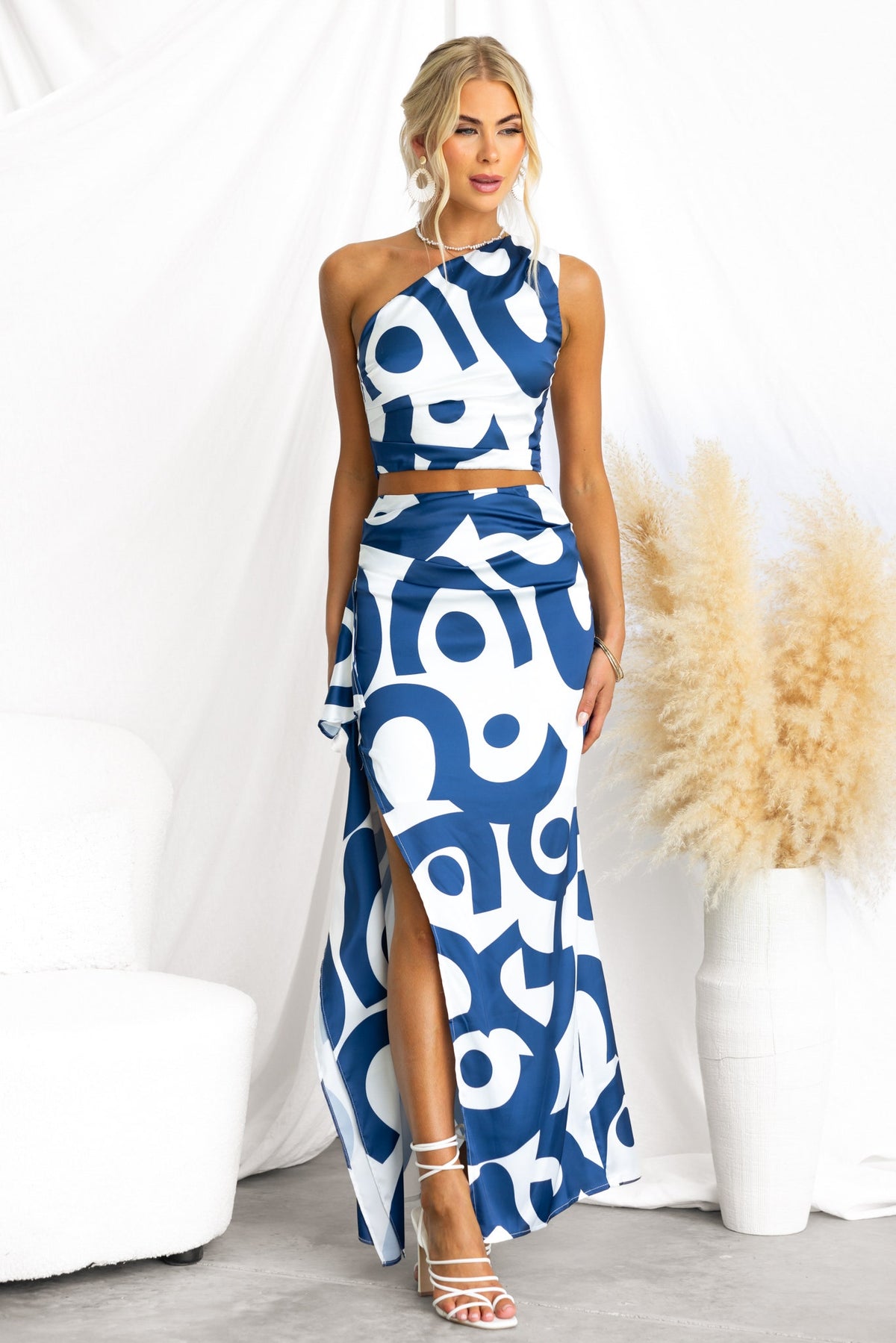 Vella Top in blue and white, one-shoulder satin style, paired with matching skirt, perfect for elegant occasions.