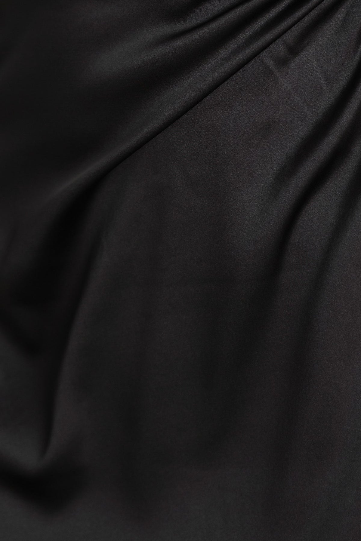 Close-up of black satin fabric, showcasing its smooth texture and elegant sheen, ideal for a stylish dress.