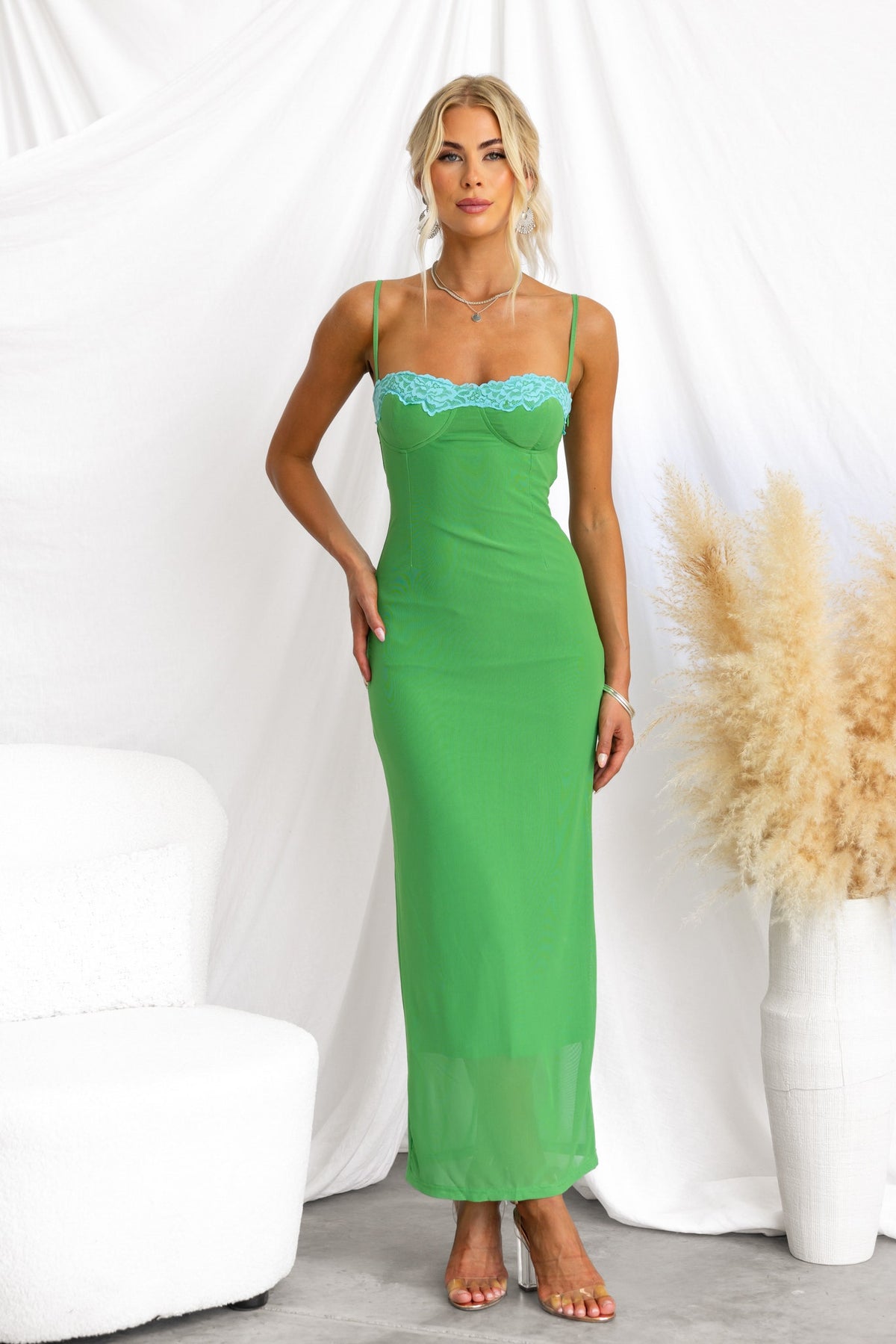 Green bodycon maxi dress with padded bust, adjustable straps, lace detail, and mesh overlay.
