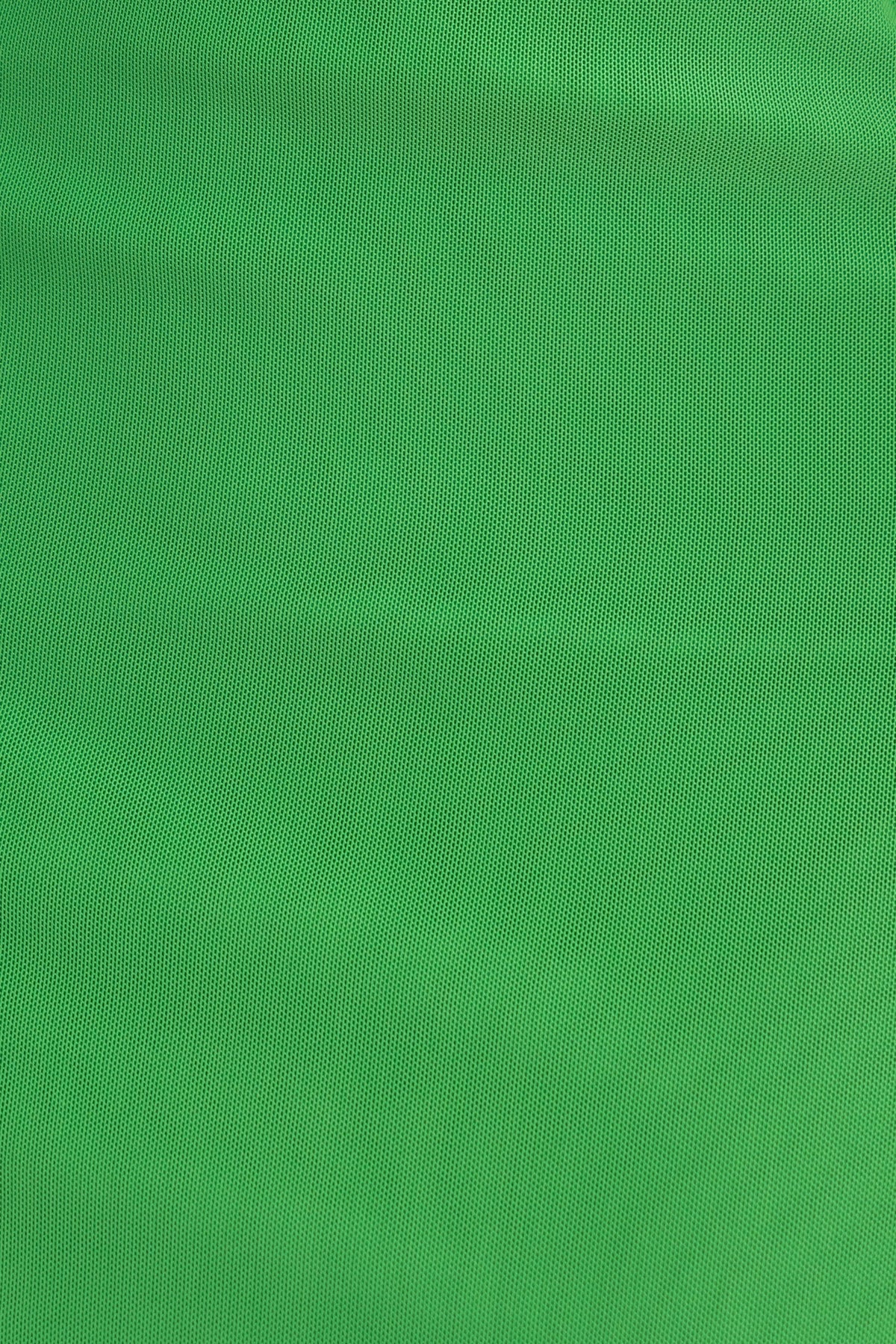 Bright green textured fabric background ideal for clothing designs and fashion items.