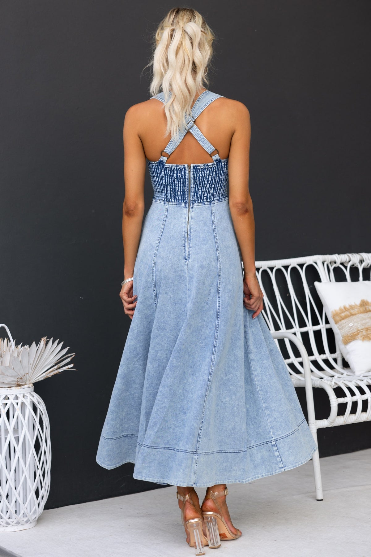 Back view of the Pallara Denim Midi Dress featuring adjustable cross-over straps and a flattering flowing skirt.