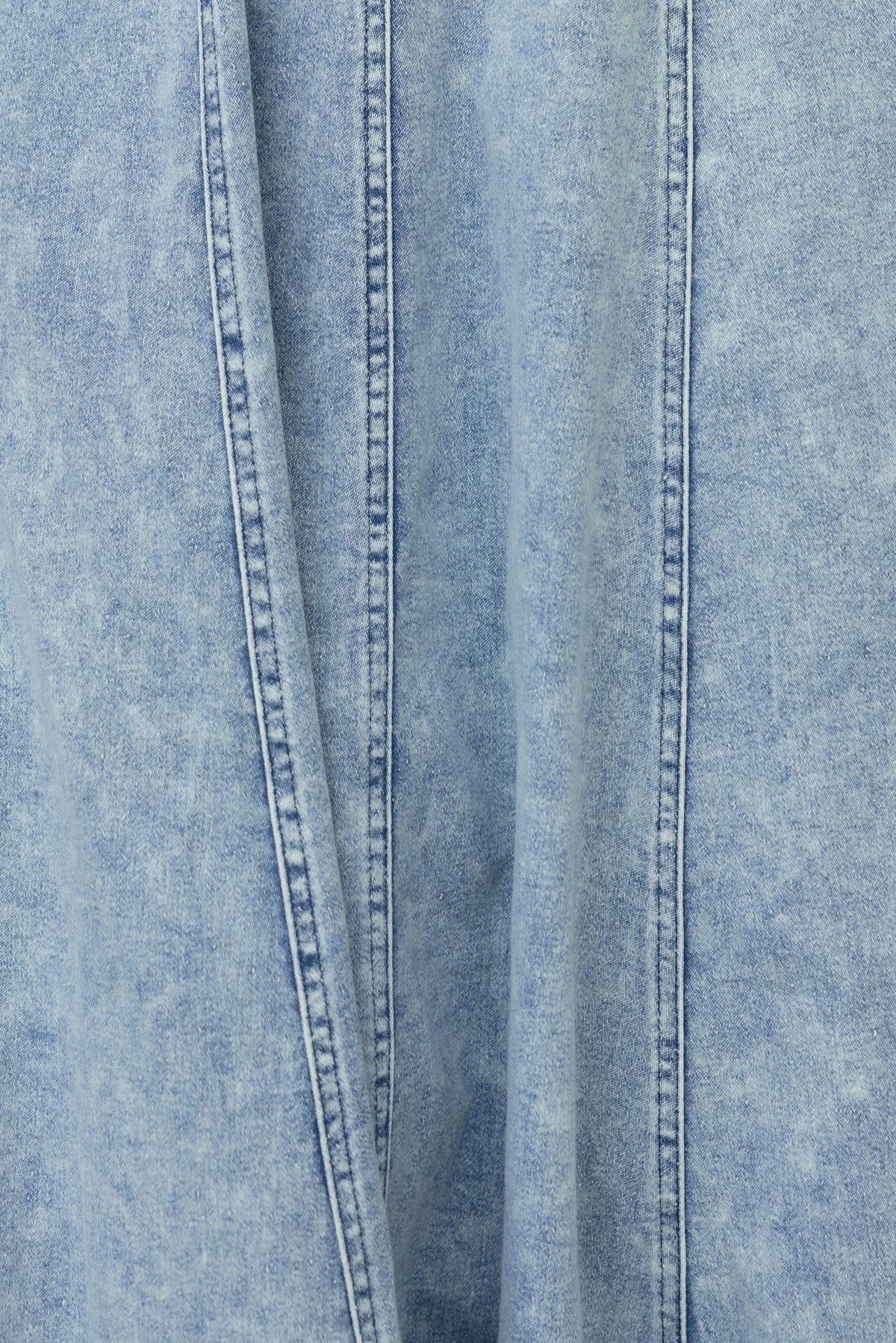 Close-up of denim fabric showcasing detailed texture and stitching for the Pallara Denim Midi Dress.