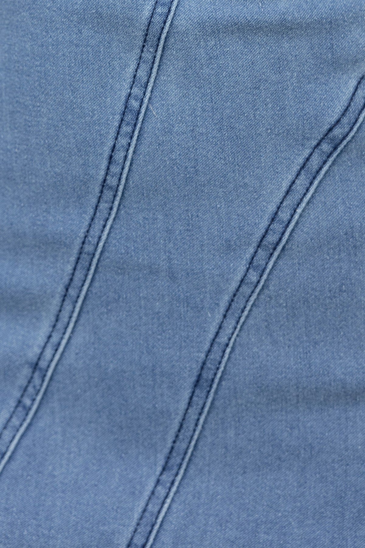 Close-up of soft denim fabric showcasing detailed stitching and texture for Chaz Denim Maxi Dress.