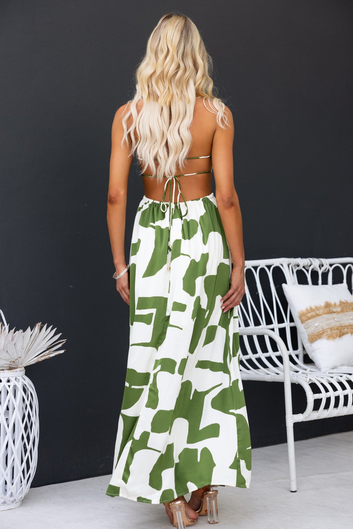 Model wearing the Dont Blame Me maxi dress featuring an abstract print and back tie detail.