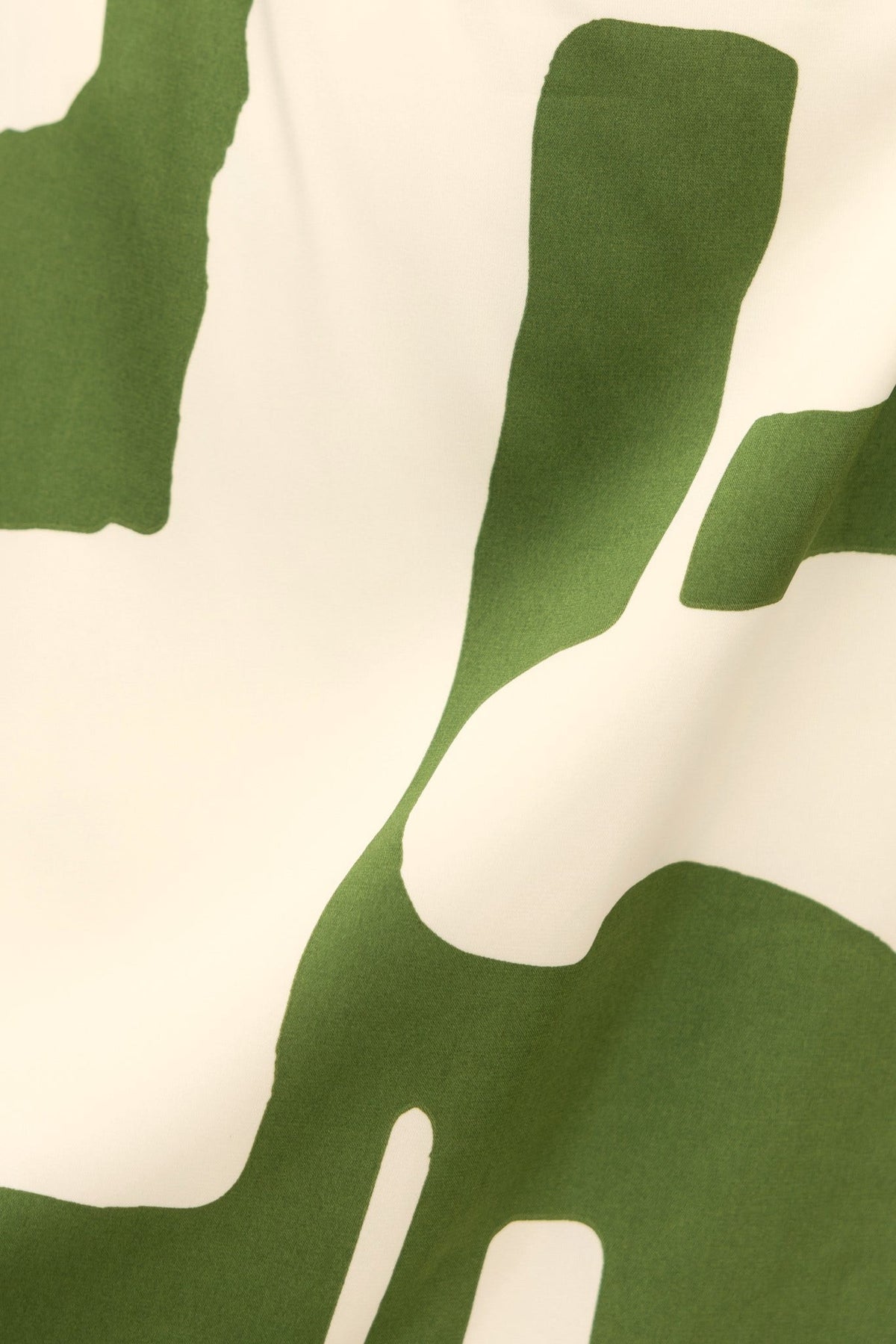 Abstract green and white print fabric, highlighting the unique design of the Dont Blame Me Maxi Dress.