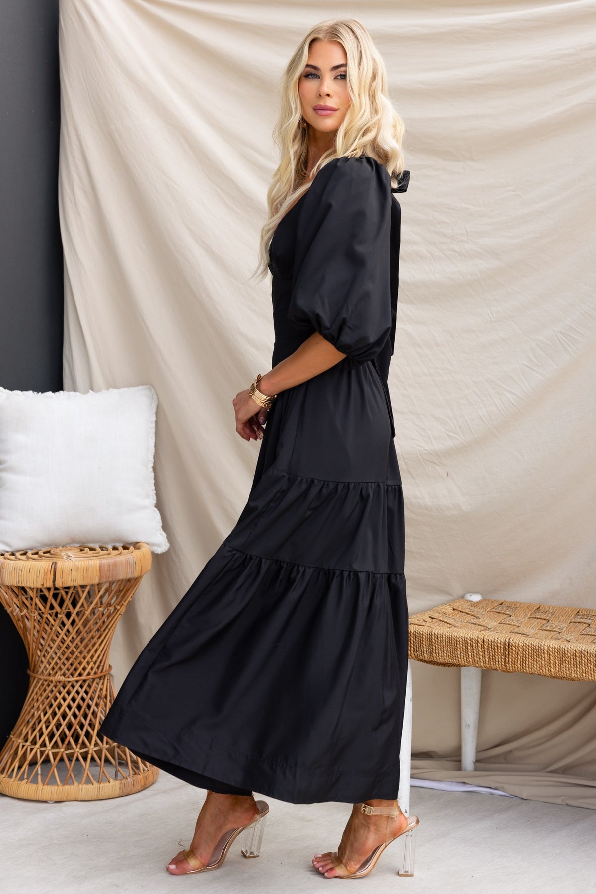 Merle Midi Dress in black, showcasing a round neckline, tie at back, elastic sleeves, and tiered design.