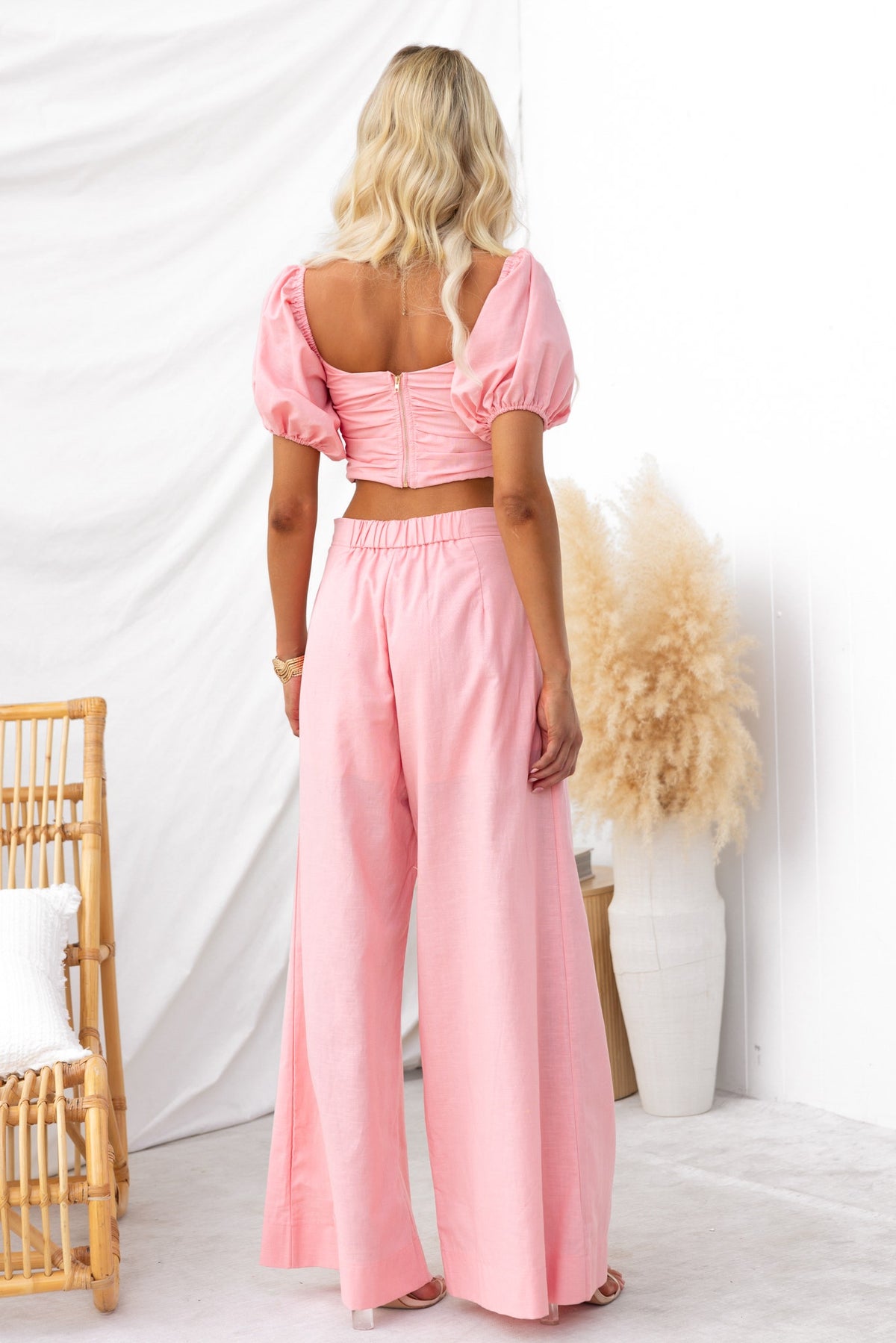 Cayson Set in pink, featuring a puff sleeve top and mid-high waist pants, showcased from the back.