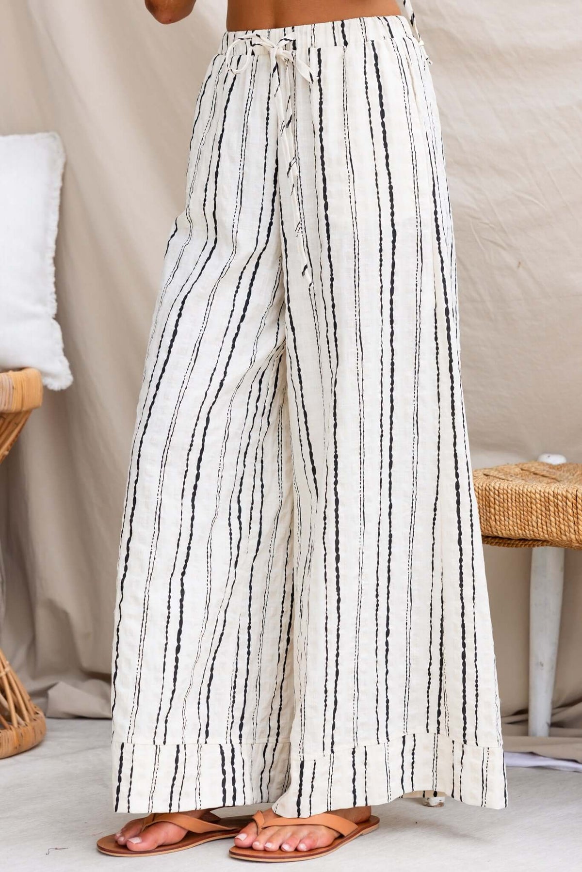 Linen Frances Pants with elastic waistband and side pockets, featuring a stylish black and white striped pattern.
