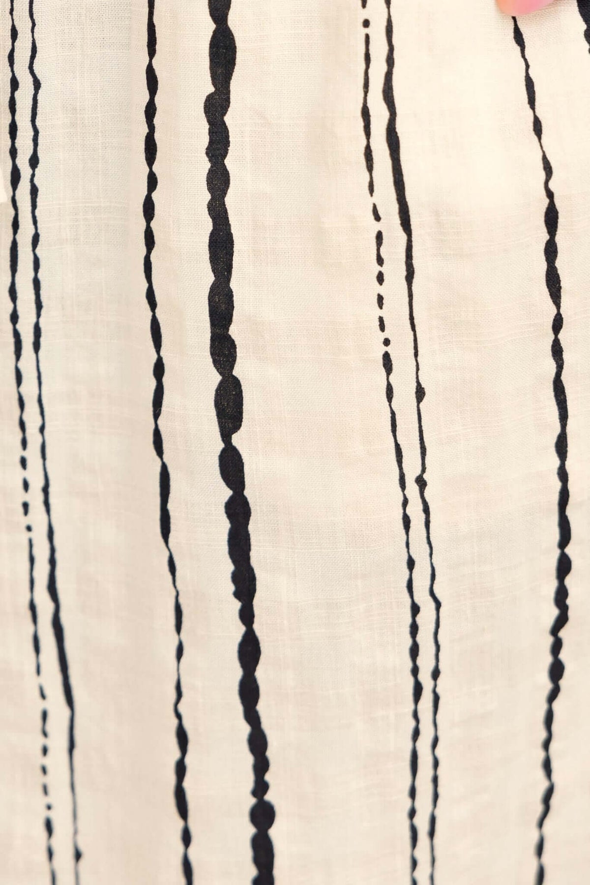 Close-up of Frances Pants featuring black vertical stripes on lightweight linen fabric.