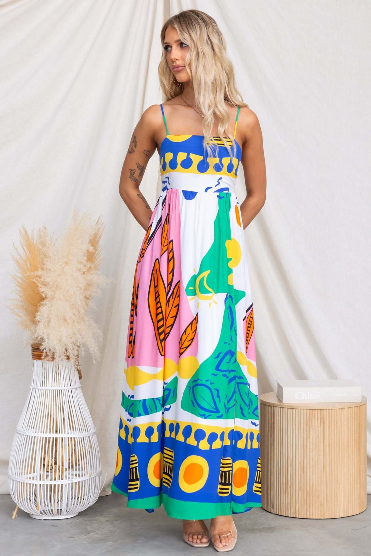 Colorful Orella Maxi Dress with adjustable straps and high front split, showcased on a model against a light backdrop.