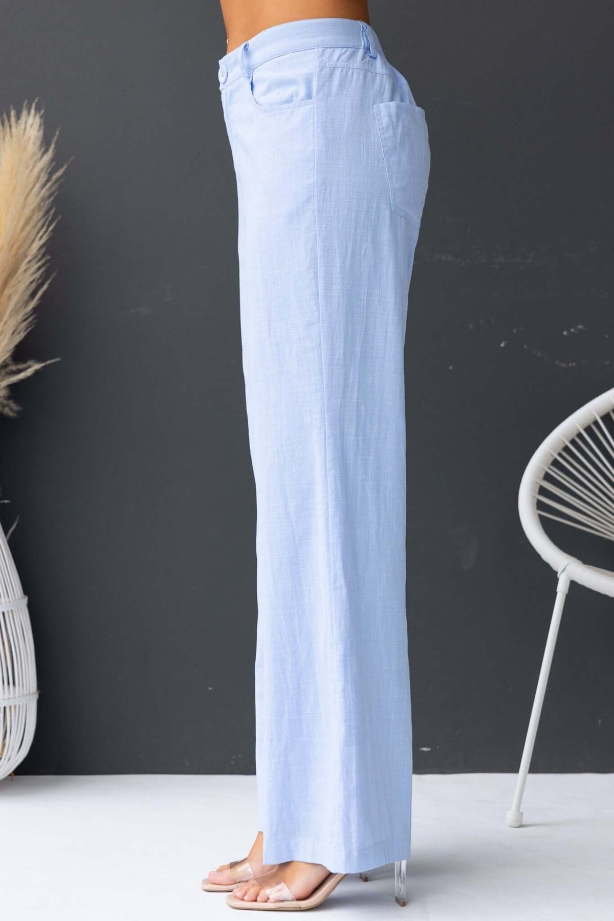Side view of Asuka Pants in light blue; mid-high waist, elastic waistband, pockets, and lined design.