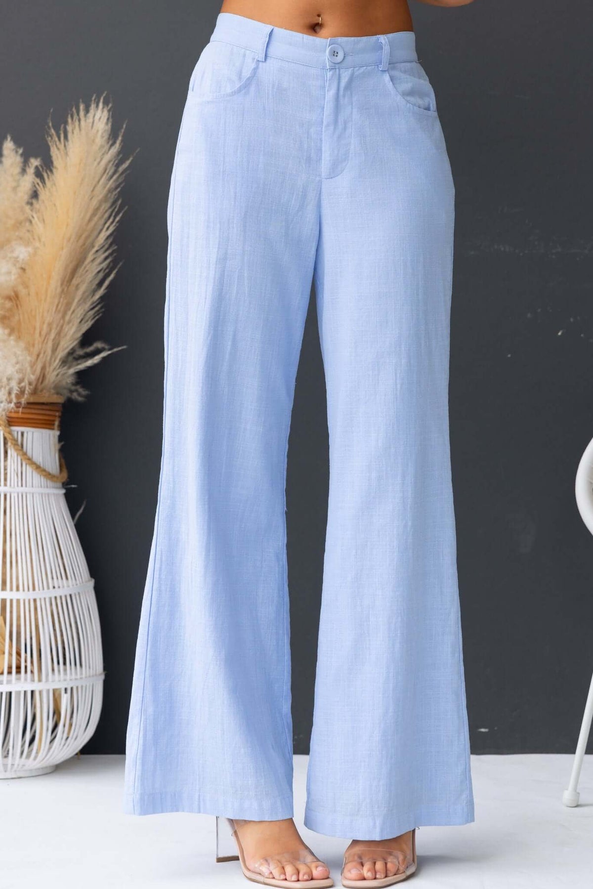 Light blue Asuka pants with a mid-high waist, elastic waistband, and wide leg design, perfect for casual wear.
