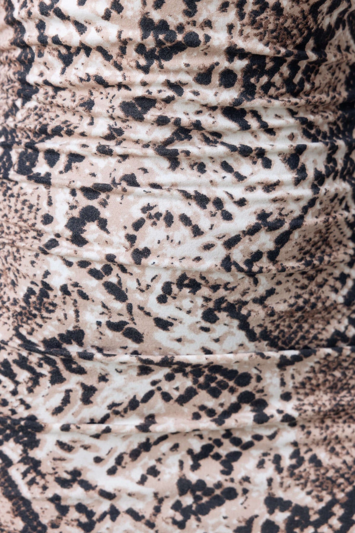 Close-up of Viper Midi Dress fabric showing stylish snake print design in shades of beige and black.
