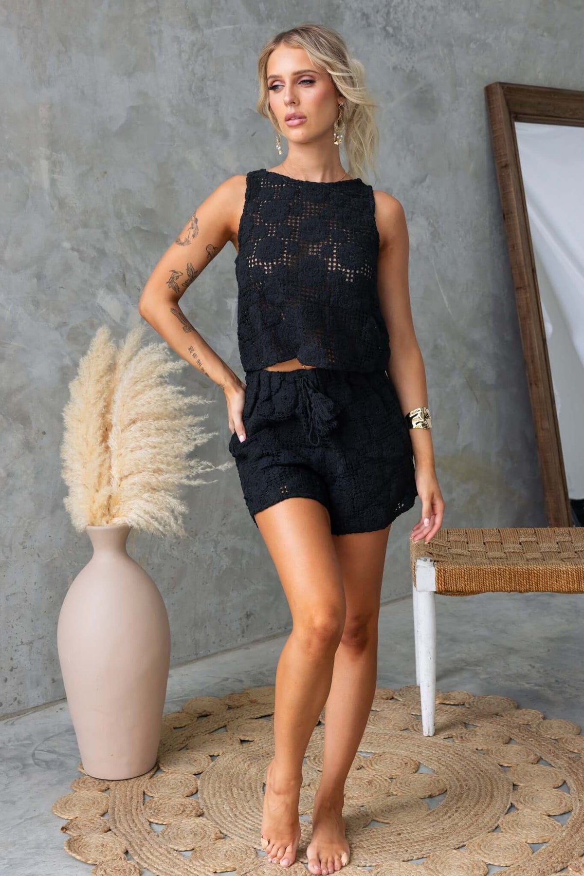 Model in Fenny Top styled with matching shorts, showcasing a relaxed fit and black crochet design.