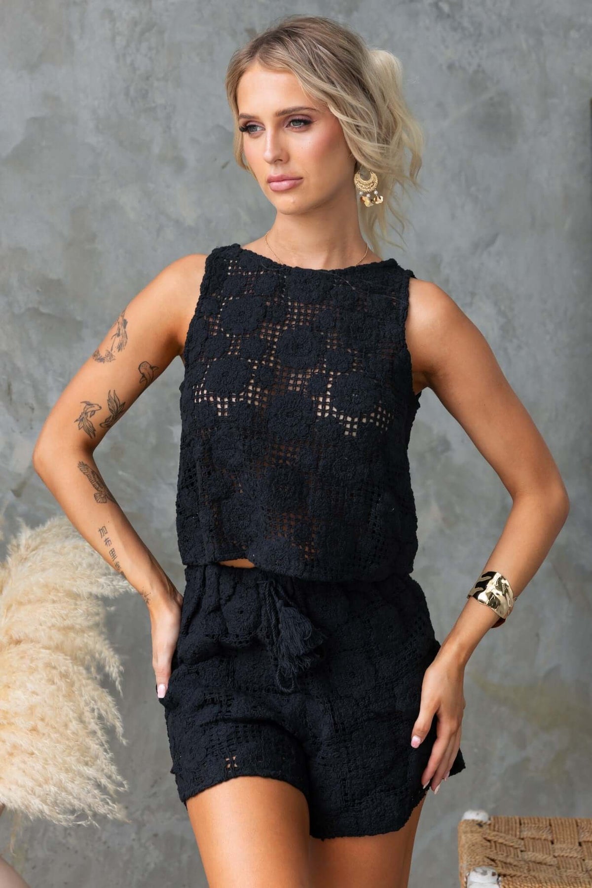 Model wearing Fenny Shorts, mid-high waist with elastic waistband, styled with a sleeveless top, perfect for summer.