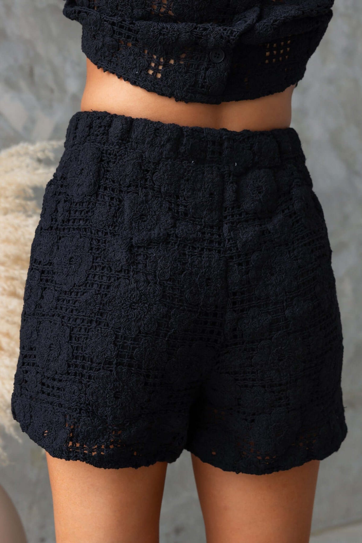 Fenny Shorts in black featuring a mid-high waist fit, elastic waistband, and textured crochet fabric.