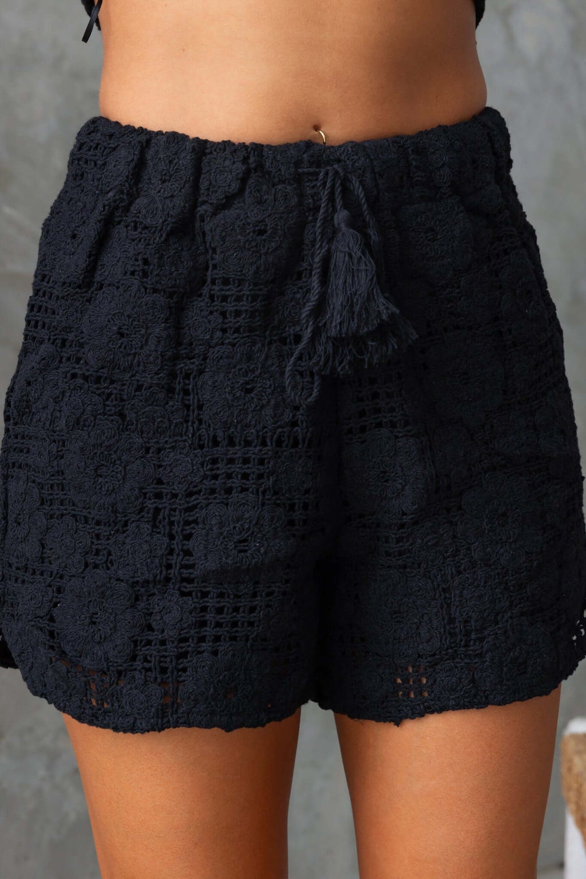 Fenny Shorts in navy blue, mid-high waist with elastic drawstring, featuring a floral lace design.
