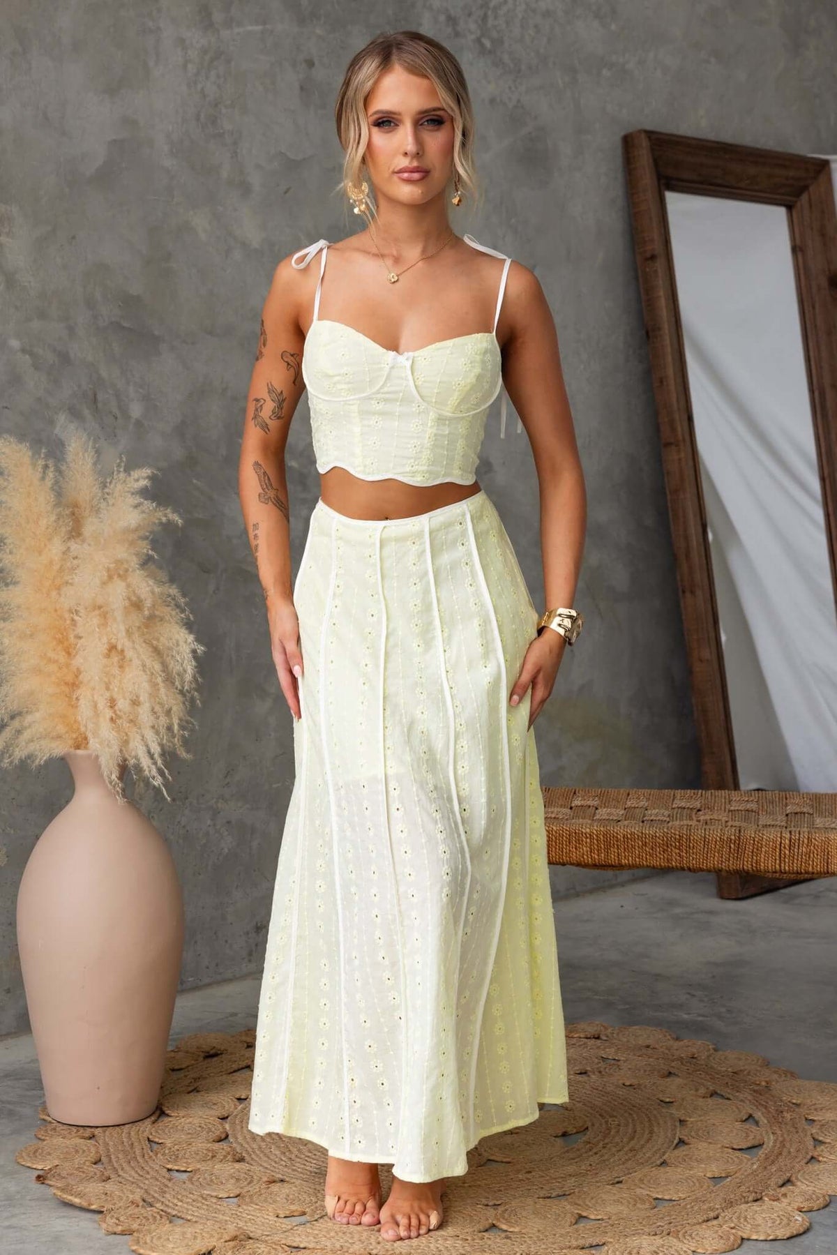Light yellow honey set featuring a lined non-stretch maxi skirt and tie strap crop top, styled in a modern indoor setting.